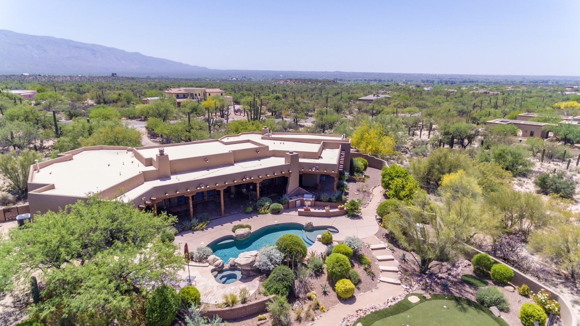 RAY BIRCH CLASSIC SANTA FE ON 3.3 AC. W/PROTECTED MTN. VIEWS. FRESHLY PAINTED EXTERIOR OVER 3 COAT STUCCO FINISH.  SW AMBIANCE THRUOUT: IMPERIAL PLASTER,   PINON LOGS, SAGUARO RIB LATILLAS, VIGAS, HAND ADZED LINTELS, KNOTTY ALDER DOORS, MANGANESE SALTILLO TILE FLOORS, 3 FIREPLACES & CUSTOM ALDER LIBRARY. GRANDLY PROPORTIONED GREAT ROOM CAPTURES MTN VIEWS. ISLAND KITCHEN: TOP OF THE LINE APPLIANCES, PREP SINK ON ISLAND, & COZY FP IN BKFAST AREA. GRAND MBR SUITE W/SPA TUB & 2 SPACIOUS CLOSETS.  GUEST WING INCLUDES EN-SUITE BR2 & ADJ. BATH W/WALK-IN SHOWER FOR BR3.   BEAUTIFULLY LANDSCAPED YARD W/EXTENSIVE FLAGSTONE PATIOS, OUTDOOR KITCHEN, PUTTING GREEN, SALT H20 POOL & SPA W/ NATURAL ROCK  WATERFALL, DEEP COVERED PORCH W/FP EXPANDS THE LIVING SPACE & FEATURES UNINTERRUPTED MTN. VIEWS.