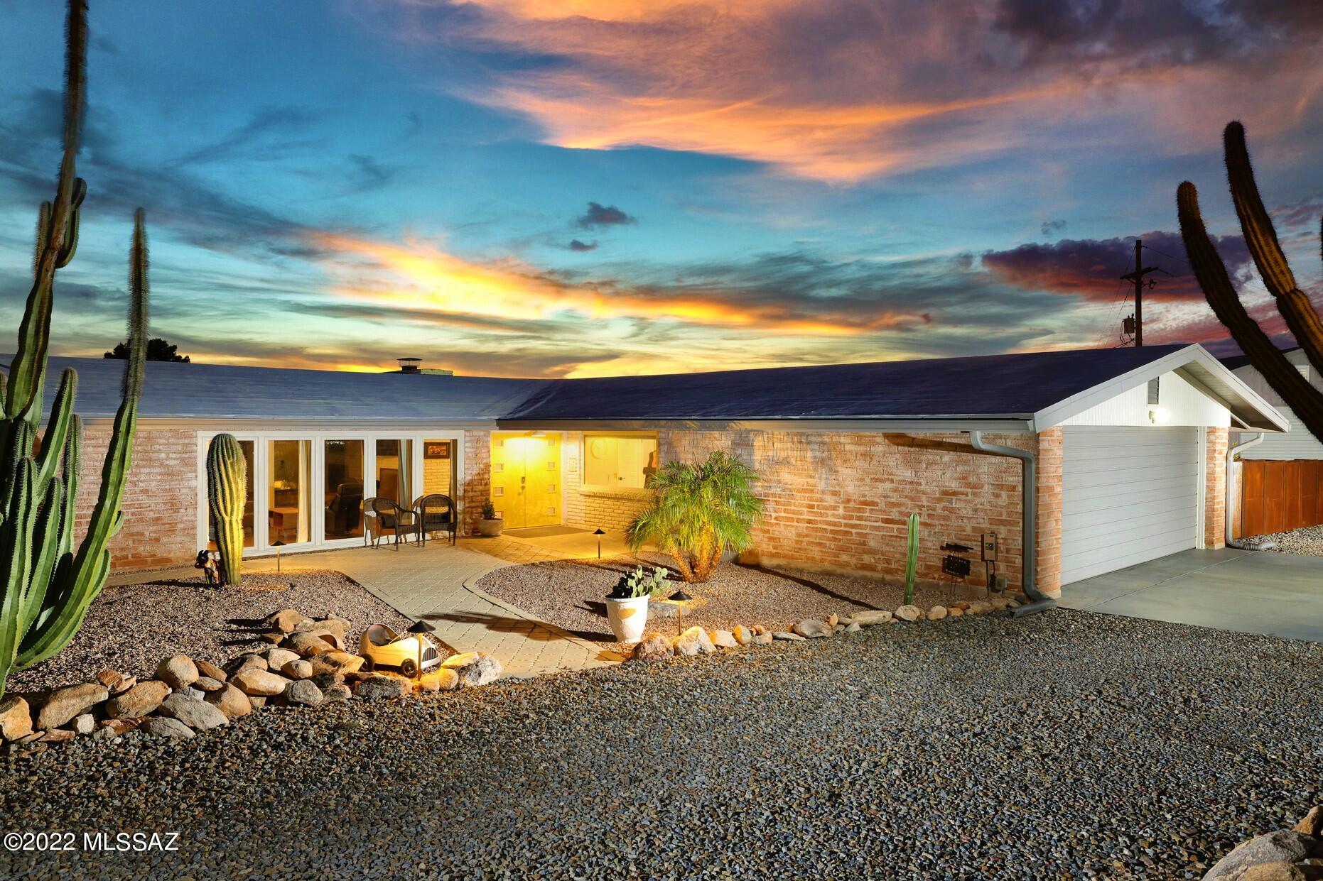 Incredible city and mountain views, sharp mid-century modern vibe, and completely redone inside and out, this is the one! If you can tear yourself away from those views, you will appreciate the impeccable attention to details throughout this stunning home. Gorgeous kitchen features waterfall quartz counters, tons of cabinets with glass-front uppers, stainless appliances including a gas range and wine fridge. Wonderful primary suite with freestanding tub, walk-in shower & dual sinks. Living area has a fabulous fireplace, walls of windows and rich wood floors. 2 separate yards with huge wrap around patios, sparkling pool & turf. 2 additional bedrooms with ensuite baths & more views. 2 car attached garage & detached insulated garage with 10' door. Plenty of room for all your toys and no HOA!