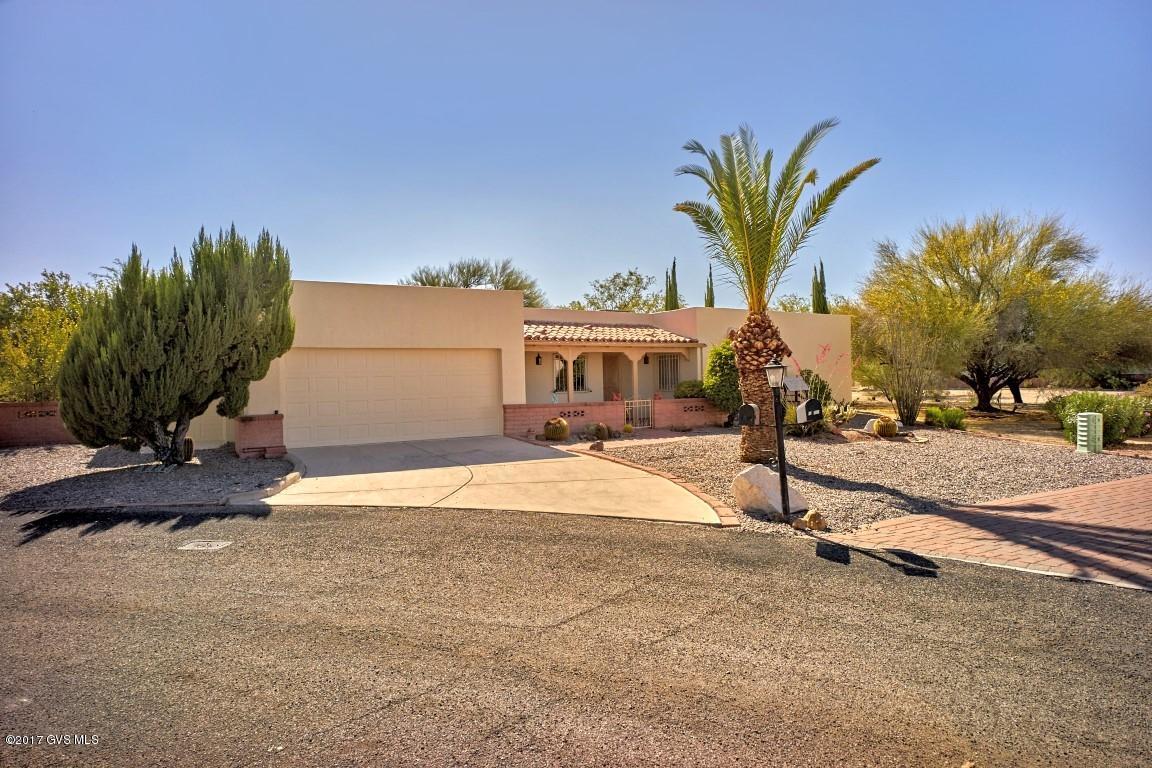 Come see this special home in the beautiful high desert of Southern Arizona. This home has a private back yard with a spectacular saguaro cactus, plus a covered patio for entertaining. Front covered porch has views of the mountains in a private cul-du-sac This home has brand new carpet with beautiful custom tile throughout. Completely painted inside and out. Wood burning bee hive fireplace in the large living room. Formal dining area as well as eat in kitchen dining. Roof was re-coated May 2017 with a two-year warranty. Three car garage, one is for your golf cart or just use for storage. Also off the garage is a great storage /work room. Very large master bedroom with walk-in closet and door to the back patio. Front Office/Guest room has a murphy bed (no mattress) and bright  windows. Second Guest room has large closets.|\n|The appliances and cabinets in the Kitchen are newer. Kitchen has a great window over the sink looking out to the back yard. This home has everything you want is a spacious desert home. |\n|