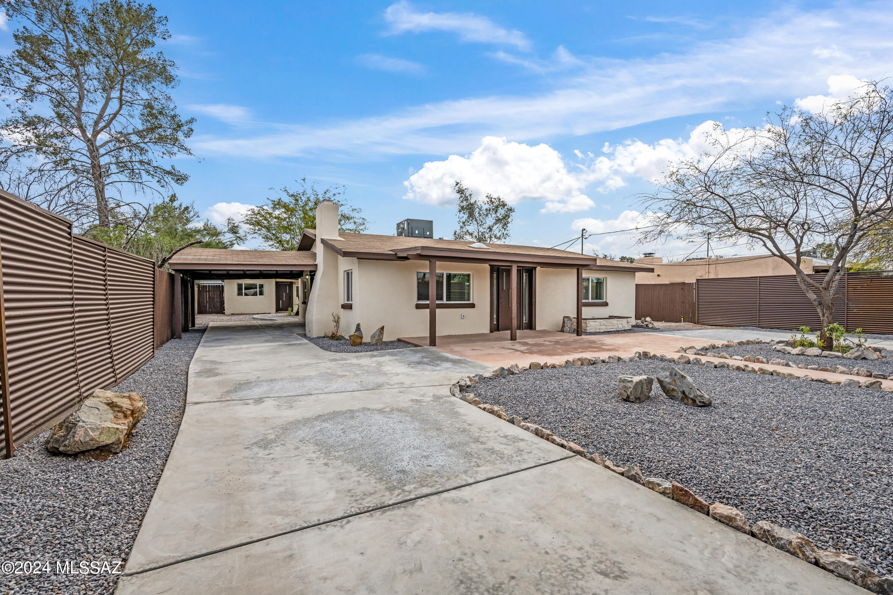 Privacy, location, flexibility... This property has everything you're looking for and more! Guarding the entrance is a custom steel gate, motorized to open remotely from the push of a button. Inside the gate, a freshly paved wrap around driveway with a separate covered carport which provides easy access and ample space for parking. Low-care gravel landscape with plenty of room for pets and toys. Both units boast tasteful updates and modern styling, with gorgeous granite counters to pull everything together. Breathtaking mountain views to enjoy all year round. Second unit is perfect for accommodating family, guests, or generating extra income. No HOA! Prime central location provides close proximity to all the amenities you need. Don't miss the chance to make this unique gem your own!