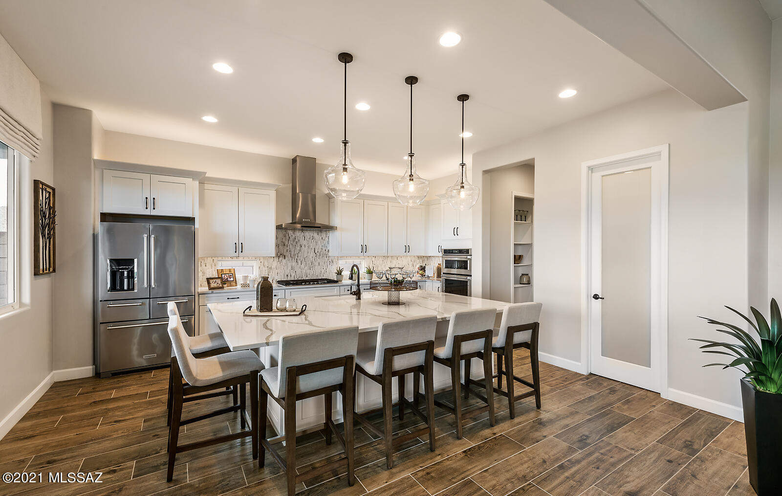 Own this one of a kind TORTOLITA MODEL HOME in Dove Mountain. Upgrades throughout the entire home including pavers, 8' interior doors, coffered ceilings, tankless water heater, and more! Gourmet kitchen features white Maple cabinets with Granite countertops in color Bianco Levanto and tiled backsplash! Under cab lighting. Off the Great room you will find the 20' glass slider which leads you to an extended covered patio and finished backyard with pavers and turf space. Owners bath is a dream with a ''spa'' feel with the tiled walk-in shower and double vanities. Upgraded modern light fixtures throughout.  Furniture will be sold with models, as separate bill of sale. This is a leaseback- contact for more details.