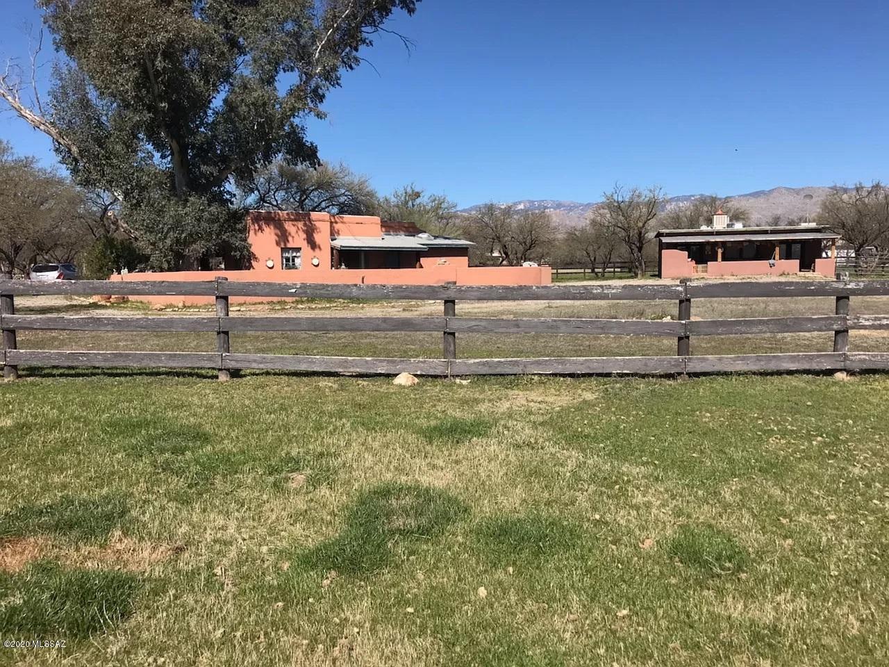 Tanque Verde Valley horse property and 2 casitas on secluded mesquite covered lot in Powder Horn subdivision. Original 1 BR/BA mud adobe casita dates to 1947 and was part of the Westinghouse ranch headquarters. Covered porches look out onto the irrigated horse pastures which surround the property on all sides. Private well serves both casitas. Zoning may permit custom home in addition to the existing casitas. Located in the gated community of Powder Horn, but property is not subject to CCR's or annual HOA dues.