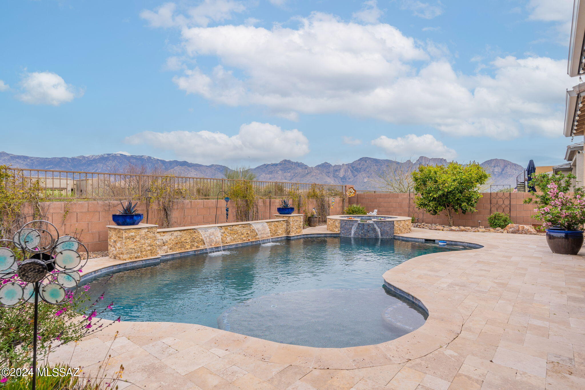 Paradise found in upscale gated Alterra. Ready for your most discerning buyers, this masterpiece features spectacular mountain views from the east-facing patio, gourmet kitchen with stainless appliances and striking granite counters, and a flexible ''Vale'' floor plan offering 4 bedrooms PLUS den PLUS teen/guest retreat. Generous Owner's Suite has an oversize walk in shower, dual vanities, custom closets, and French door to patio. Home also features plantation shutters, water softener, wood-look tile, wrought iron security door, and epoxied 3 car garage. Step outside to experience outdoor living at its finest, with heated pool with waterfall, relaxing spa, gas firepit, pergola with built in BBQ, fruit trees and travertine pavers/pool decking. Not to be missed!
