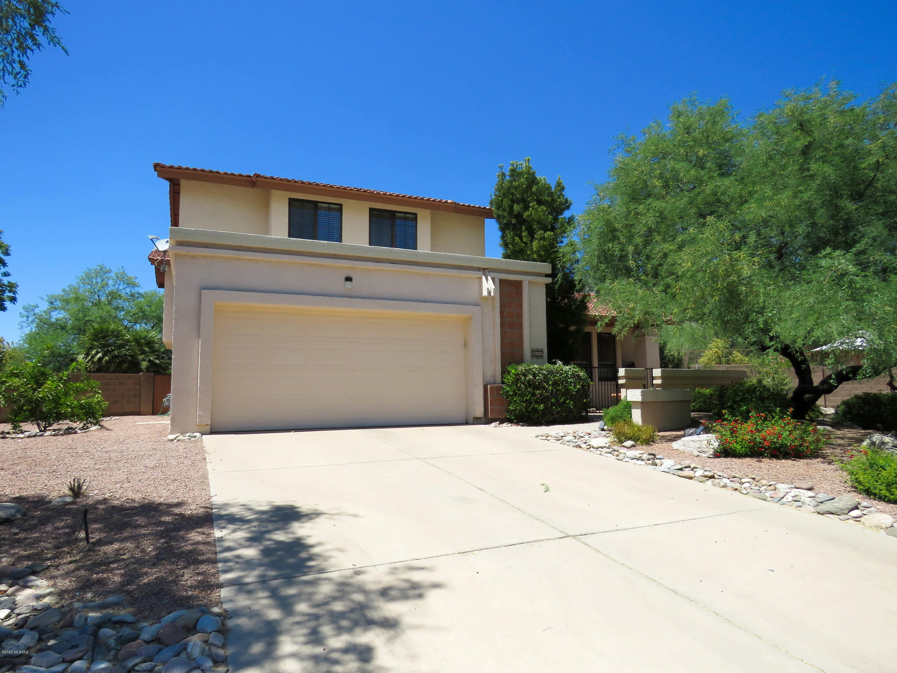 Breathtaking mountain views from this beautiful 4 bedroom 3 bath home. The family room leads onto a covered patio and garden where hummingbirds, cardinals and other wildlife love to visit. Living room and private dining area boasts vaulted ceilings, kitchen has quartz counter tops, SS appliances & breakfast area. Large master suite with vaulted ceilings and private balcony overlooking Catalina mountains. 2 upstairs guest bedrooms share tasteful full bath, 4th bedroom downstairs offers built-ins for an office, craft room or home schooling. 3rd full bath is located downstairs. This home is a must-see, located on the best lot in subdivision! Very quiet neighborhood & peaceful setting as corner lot. Some furnishings available on separate bill of sale.