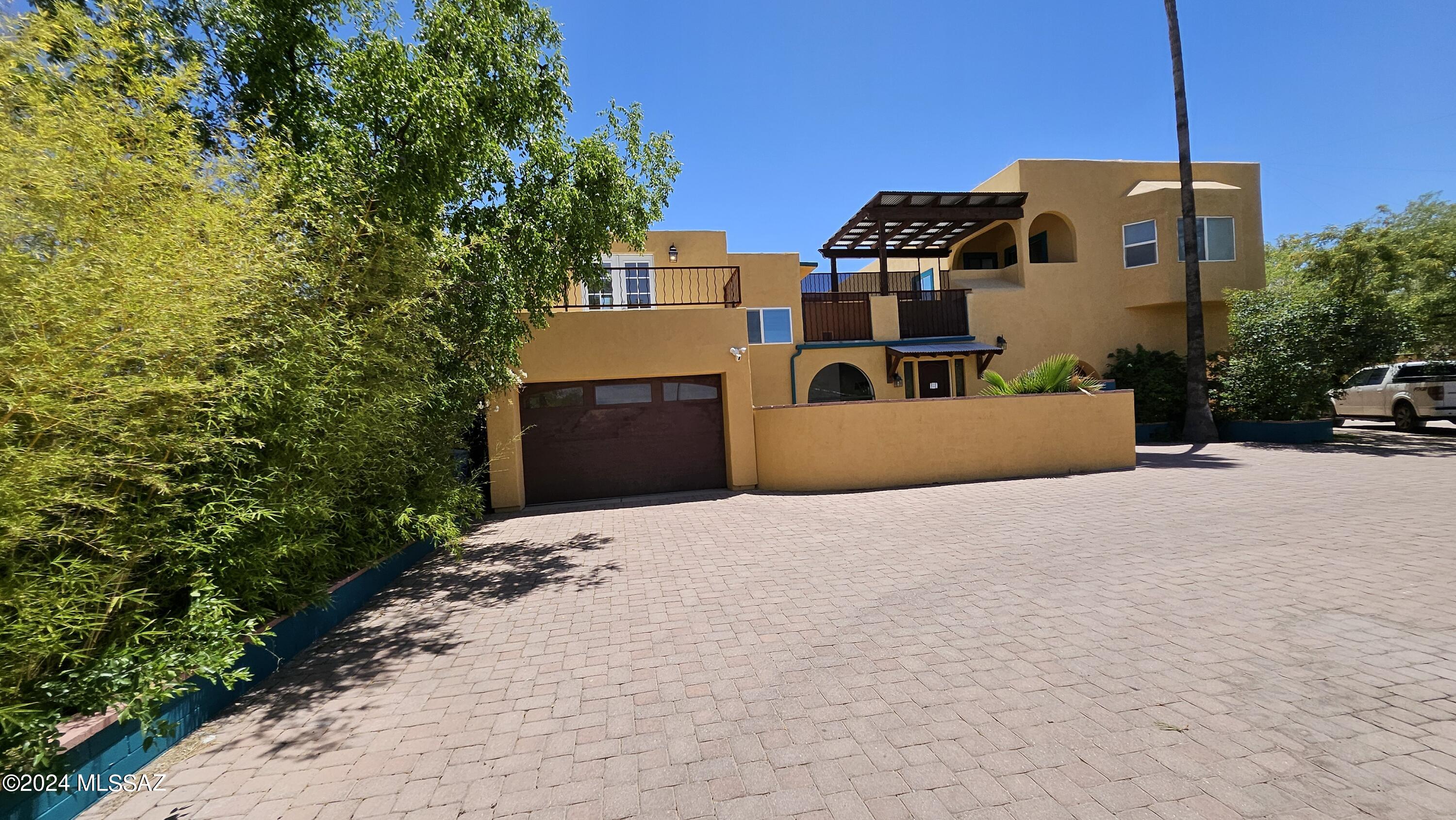 Hidden oasis right in the middle of town!   Large spacious home with a lush backyard just minutes from your favorite restaurants, UofA, Tucson Racquet club, Park, river walk.  This home is surrounded by walls and tucked almost 150 feet back from the street with a long driveway to a gated entrance.  
This home is very functionable with extra storage closets, pantry, shoe closet and two exterior storage rooms for tools or hobby supplies.  
Two offices in the home could be used as extra bedrooms if more rooms are required.