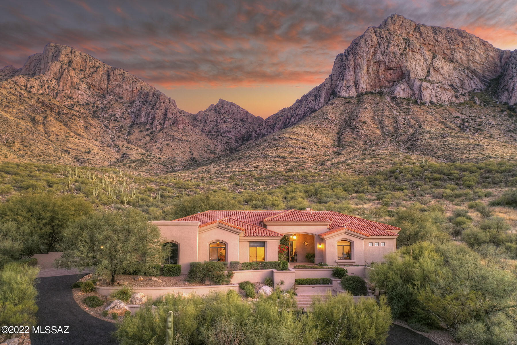This tastefully remodeled & updated 4,363 sq. ft. contemporary is on a private cul-de-sac backing up to a no-build wilderness area and the Coronado National Forest. The 5-bedroom, 5 ½-bath masterpiece is nestled in prestigious, gated La Reserve on a stunning 2.279-acre lot and offers unobstructed city or dramatic mountain views from every room! Highlights include travertine stone flooring, soaring ceilings, walls of windows, no interior steps, a living room with a formal dining area & a grand fireplace, a butler's pantry with cabinetry & wine fridge, and a 3-car garage. The family room, open to the kitchen, features an entertainment wall with cabinetry, walls of glass, and a floor-to-ceiling stacked stone fireplace. The fabulously remodeled chef's kitchen provides and oversized center island, all new cabinetry, granite countertops, and stainless steel appliances including a professional gas range. The gracious primary bedroom offers a cozy fireplace, picture windows, access to the covered back patio, and a luxurious bathroom complete with, dual walk-in closets with built-ins, dual vanities, a garden tub & a separate walk-in shower. Enjoy the beautiful outdoor living areas featuring an expansive porch with a built-in barbecue, a large grass yard, a re-plastered pool & spa with a waterfall feature & boulder accents, and breathtaking mountain views.
