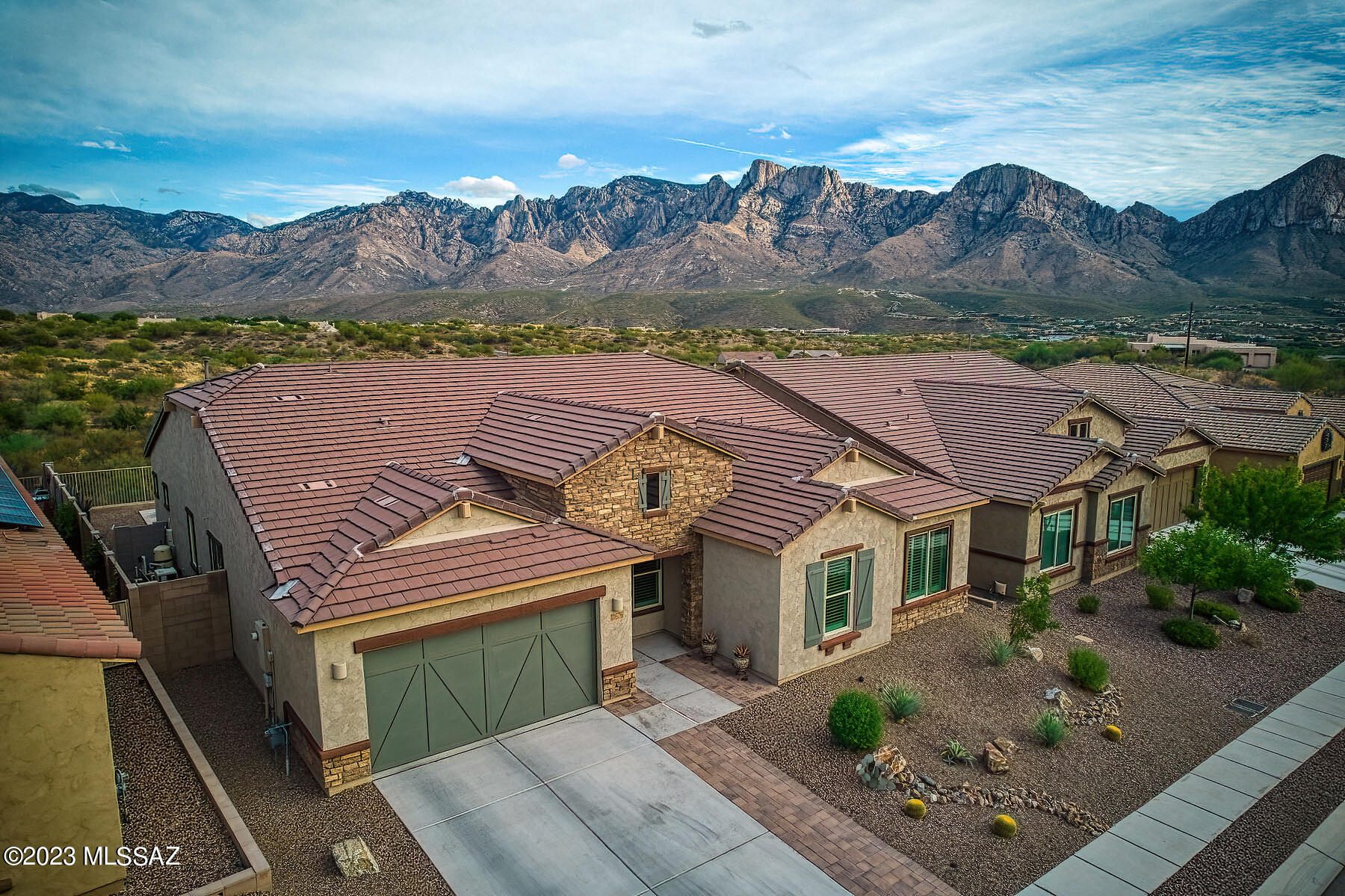 Absolutely stunning 4BD/2.5BA (3045 sq ft) home with pool/spa & breathtaking mountain views in the Villages of Silverhawke community. The exceptional views of the Catalina Mountain, visible from anywhere in the backyard, will not disappoint. Whether in the spool, utilizing the built-in BBQ grill, or relaxing by the gas fire pit, the backyard is truly resort style living.  The interior is spectacular with GE Cafe style appliances, featuring a fridge with a built-in Kerig.  The split floor plan home is perfect for entertaining with a media area and beverage center.  Work up a sweat in the exercise room. You also have a 3-car tandem garage, and a laundry room w/ wash basin.  This is the home to see in Oro Valley.