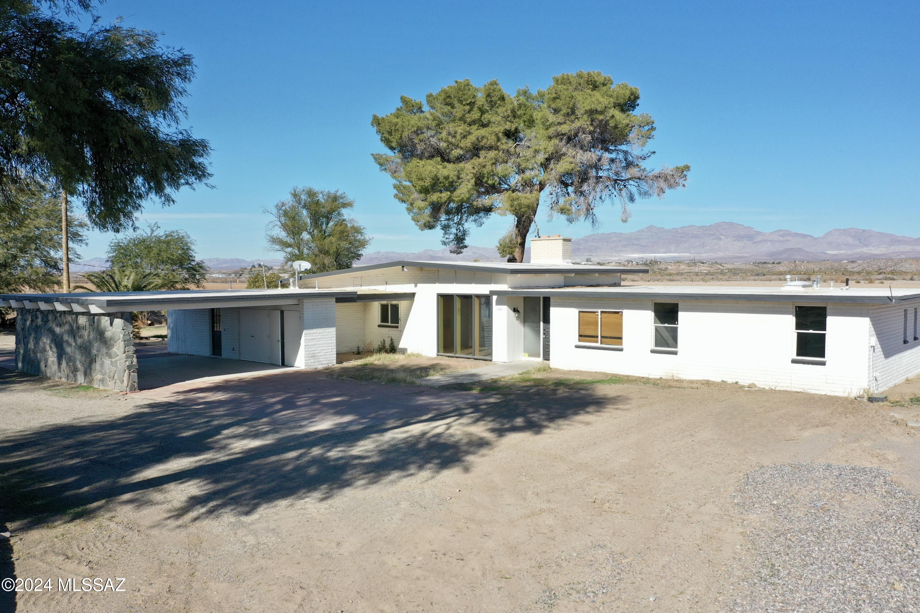 Welcome to your dream property! This spacious 3-bedroom, 3-bathroom home offers 2,635 square feet of comfortable living space, nestled on 4 acres of serene land. New Windows recently installed, ensuring energy efficiency and a fresh, modern feel. The home boasts a newly painted exterior, adding to its curb appeal. In-Ground Fire Pit that's ideal for entertaining, enjoy cozy nights around the fire with friends and family. Stunning views of Mt. Graham that provide a perfect backdrop for this lovely home. This property is a true gem with its combination of space, amenities, views and, irrigation for your future mini farm. The property to the south with the warehouse can be purchased together with this home - see MLS# 22519402