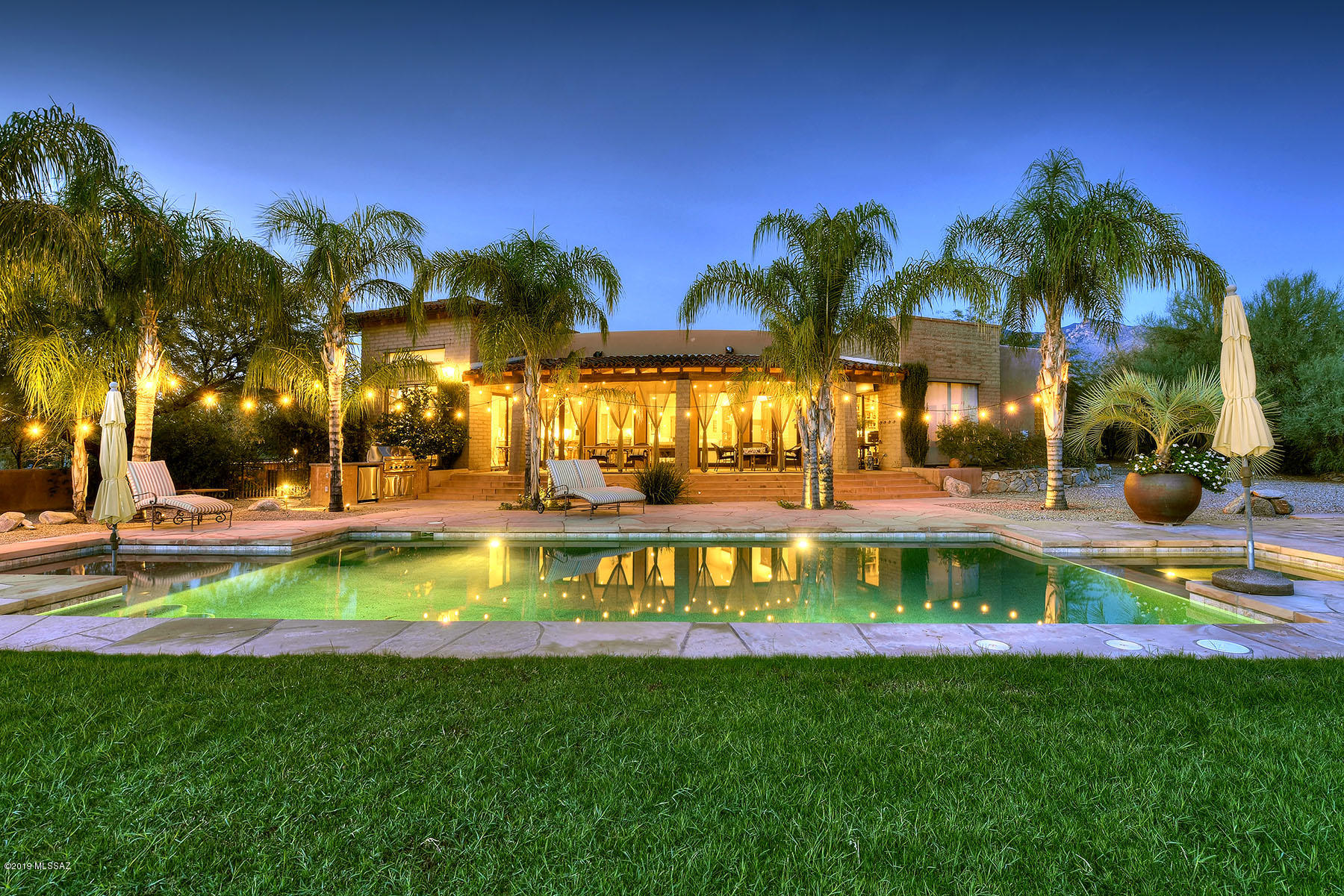 Words and photos can't capture the beauty of this stunning mud adobe contemporary, featured on the front cover of Tucson Lifestyle Magazine, with 4 bedrooms, 3 ½ baths, 3,926 sq. ft. and located on a .83 acre lot in the high central Catalina Foothills in a neighborhood with no CCRs or HOA dues.  Courtyard entry with fountain leads into living room with soaring beamed and planked cathedral ceiling, elegant and classic chandelier, exposed mud adobe wall and masonry fireplace.  Enter the spacious great room/kitchen with fireplace, high ceiling, walls of windows, fireplace, chef's kitchen with SS appliances, granite counters, center island with breakfast bar, knotty alder cabinets and dining area with soaring beamed and planked ceiling and rustic/elegant chandelier. Two bedrooms offer sitting rooms with Jack and Jill bath and 4th bedroom currently used as office has walk-in shower.  Glorious master suite features fireplace, walk-in closet and glass shower, dual vanities and garden tub.  Yards have expansive covered porches, oversized grass play area, lap pool, 8' X 8' spa that holds 8-10 people, outdoor kitchen, outdoor fireplace with banco seating and extra yard with basketball court, large enough for a full guest house.  See unobstructed city and mountain views from the observation deck.  Art, character, quality, charm and so much more that you won't want to miss.