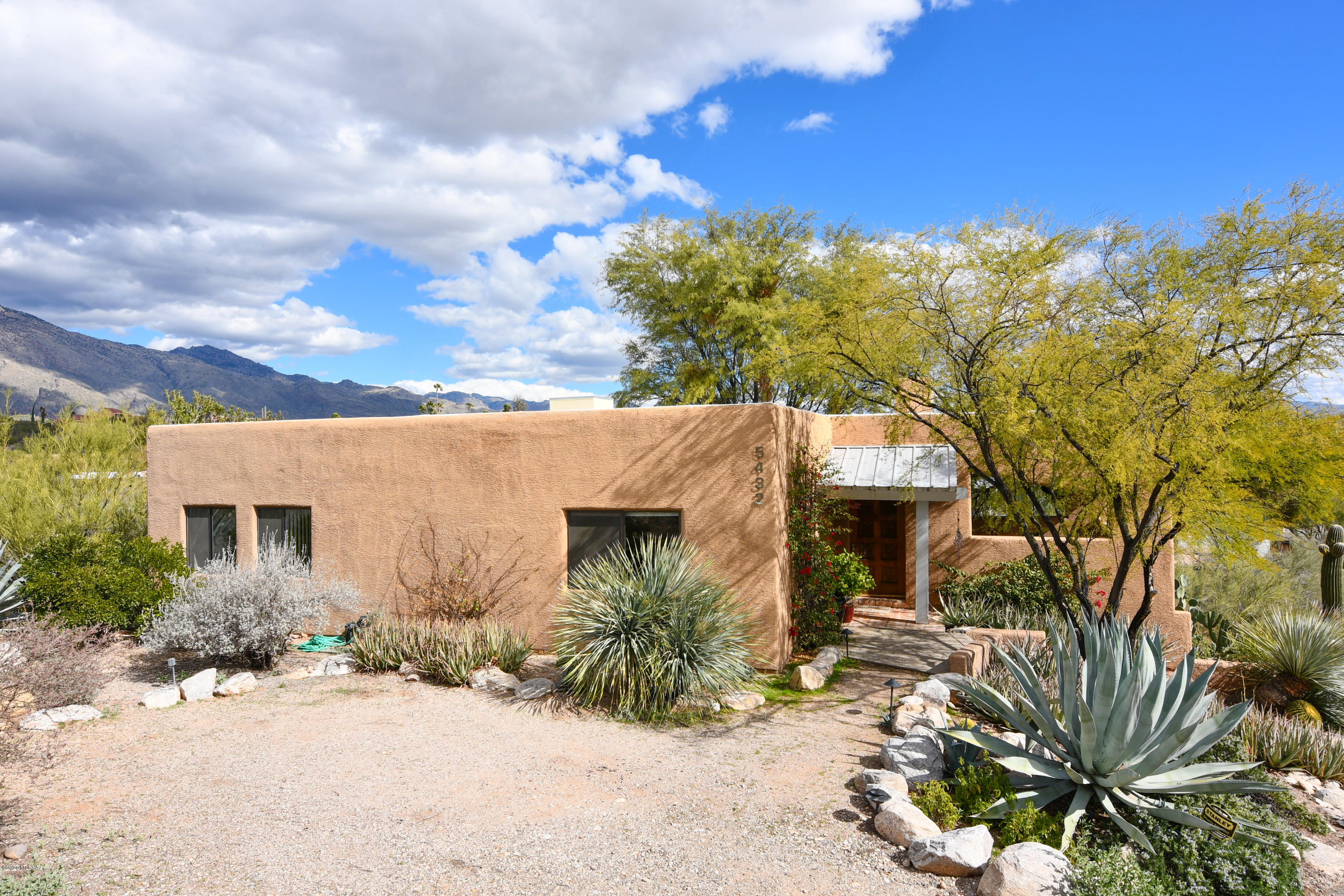 Panoramic Catalina Mountain & City Lights Views from Inside & Out of this Wonderful Foothills Home Formerly Featured in Sunset Magazine. Serenely Situated in a Tranquil 1+ Acre Natural Desert Setting with Saguaros, Agaves &  Desert Plantings. Substantially Constructed Custom Home with Solid Posts, Beams & Rough Hewn Wood Plank Ceilings. Kitchen with Slab Granite Counters, Glass Cooktop with Stainless Hood & Sub-Zero Refrigerator. Open Family Room with Inviting Fireplace. Dining Room with Picture Windows Capturing the Catalina Mountain Views for Entertaining. Master Suite with Double Closets & Ensuite Bath. Laundry Room with Cabinets & Powder Room. Intimate Outdoor Living Space with an Outdoor Kitchen, Outdoor Fireplace, Water Feature & Hot Tub. Decks & Porches for Taking in the Views.