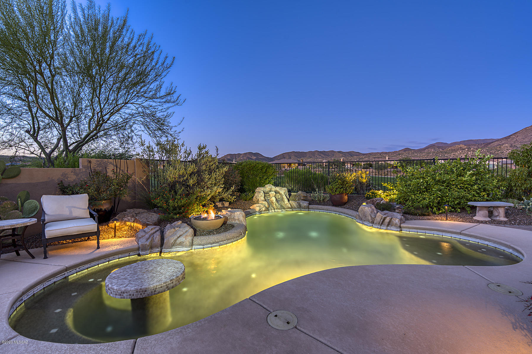 Enjoy unobstructed golf & mountain views. Welcoming courtyard w Kiva fireplace leads to this beautiful Sabino model w old-world Spanish charm, guest Casita & many upgrades.  The views spread out before you upon entering. Great room anchored by a Spanish style fireplace, open beams, & built-in bookcases. Gourmet kitchen w stainless appliances, stone counters & cherry wood cabinetry is open to dining area & great room. Master suite has en-suite w large shower, soaking tub, walk-in closet, & attached laundry/closet w built-ins. Private guest suite, convenient den, lighted wine closet, powder room, tile throughout, plantation shutters, & 3 car side entrance garage. Expanded paver patio, built-in BBQ, free form pool & hot tub is the perfect place to enjoy the views & the best of SaddleBrooke.