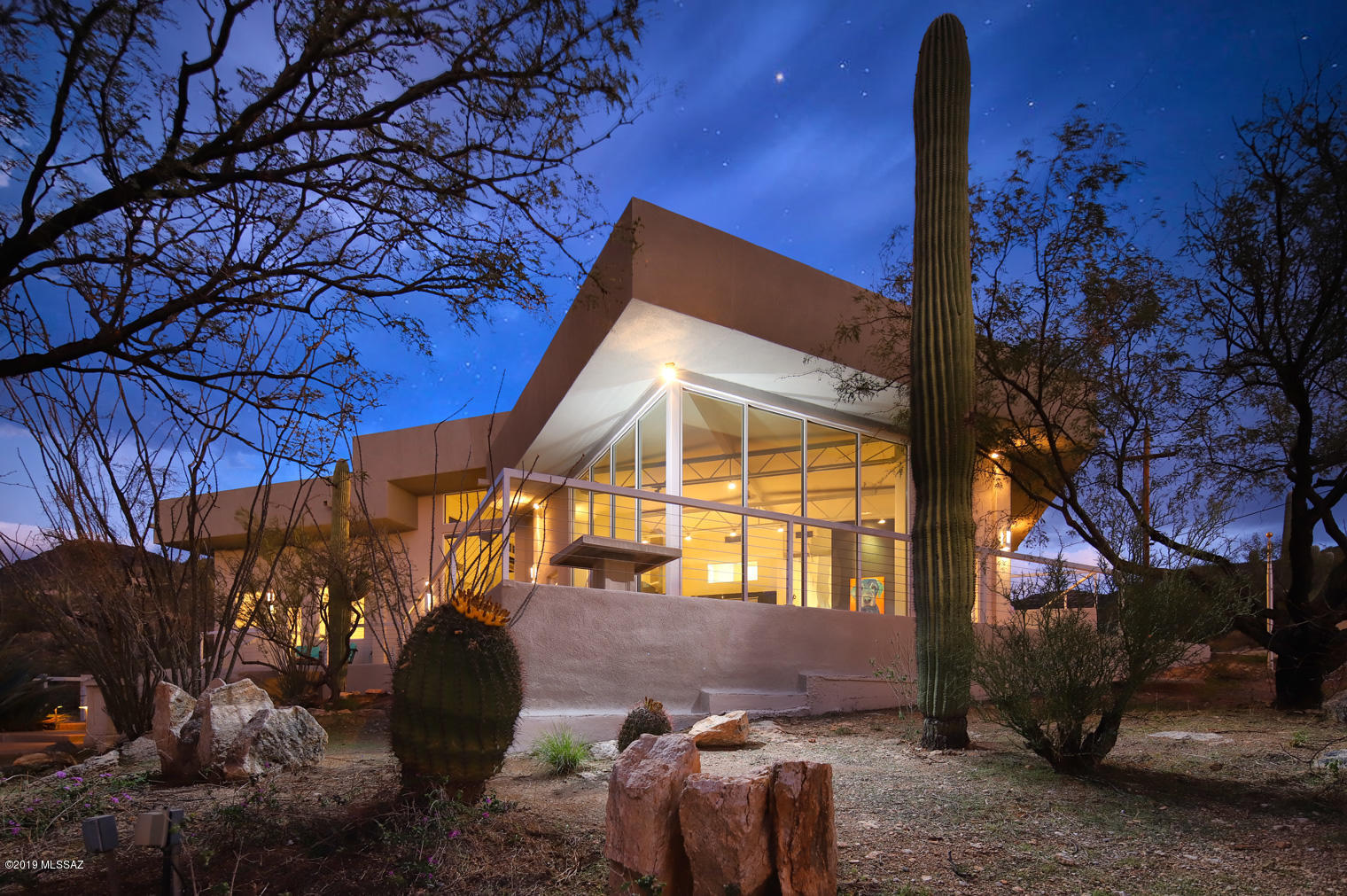 Welcome to ''Rancho Dos Perros'' where stunning modern architecture meets unparalleled panoramic views. The greatroom offering sky-high ceilings & walls of glass is open to the contemporary kitchen w/sleek cabinetry, quartz counters & SS appliances. Spacious living & dining areas offer spectacular views of La Milagrosa Canyon. Luxury master w/commercial glass doors, loft, spa-like bath w/jetted tub, lrg walk-in shower, dual sinks, vanity area, 2-way FP & huge closet. 2 addl bedrooms in the main house, plus studio/guest quarters w/half bath, perfect for art studio, gym or the ultimate man cave. Viewing decks all around plus rooftop deck. Set at the base of the Coronado National Forest, this lush riparian area is a paradise for hikers, birders & mountain bikers! Adjacent 3.31 acres available