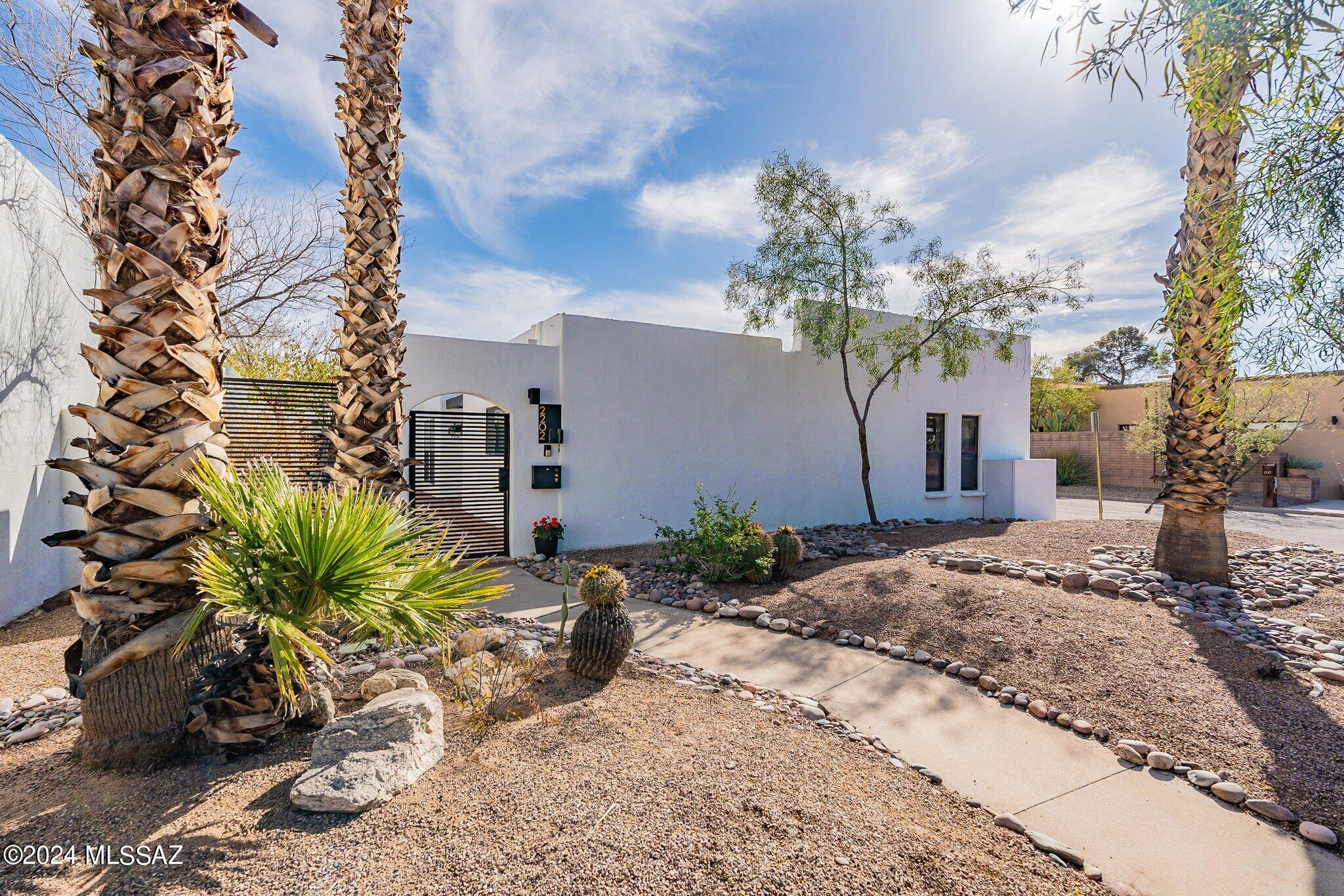 Territorial / Modern home. You'll appreciate your home being nestled in the Prestigious & Historical Blenman-Elm Neighborhood. Located in the Heart of Tucson & walking distance to UofA campus, Banner University Hospital, parks, dining , night life & The iconic Arizona Inn. The Owner's transformed this home in 2021, which features all New Pella windows, Jeld-Wen French doors,Luxury Vinyl flooring.New & spacious Kitchen w/ All New Kenmore Applances, Custom Cabinetry & Drawers surrounding large Center Island that flows seamlessly into expanded Great room. Everyone is Happy w/ 4 spacious bedrooms/ 4 full bathrooms & the split floor plan providing the primary suite.. w/ a nice retreat & separate back patio access. Also a 160sqft  Media room, Ring full home security & Temp controls, NUVO full home Soft & Filter water system. See attached listed upgrades to provide the new owner w/ all the comprehensive upgrades that ensure peace of mind for a tranquil living experience. Exterior features a corner lot, attached large 2 car garage w/ extra storage( partially open sided to enclosed back patio), brick paver back patio w/ desert plantings. Roof, (2)HVAC & Termite services are all under warranty & recent inspections & service. No HOA's.