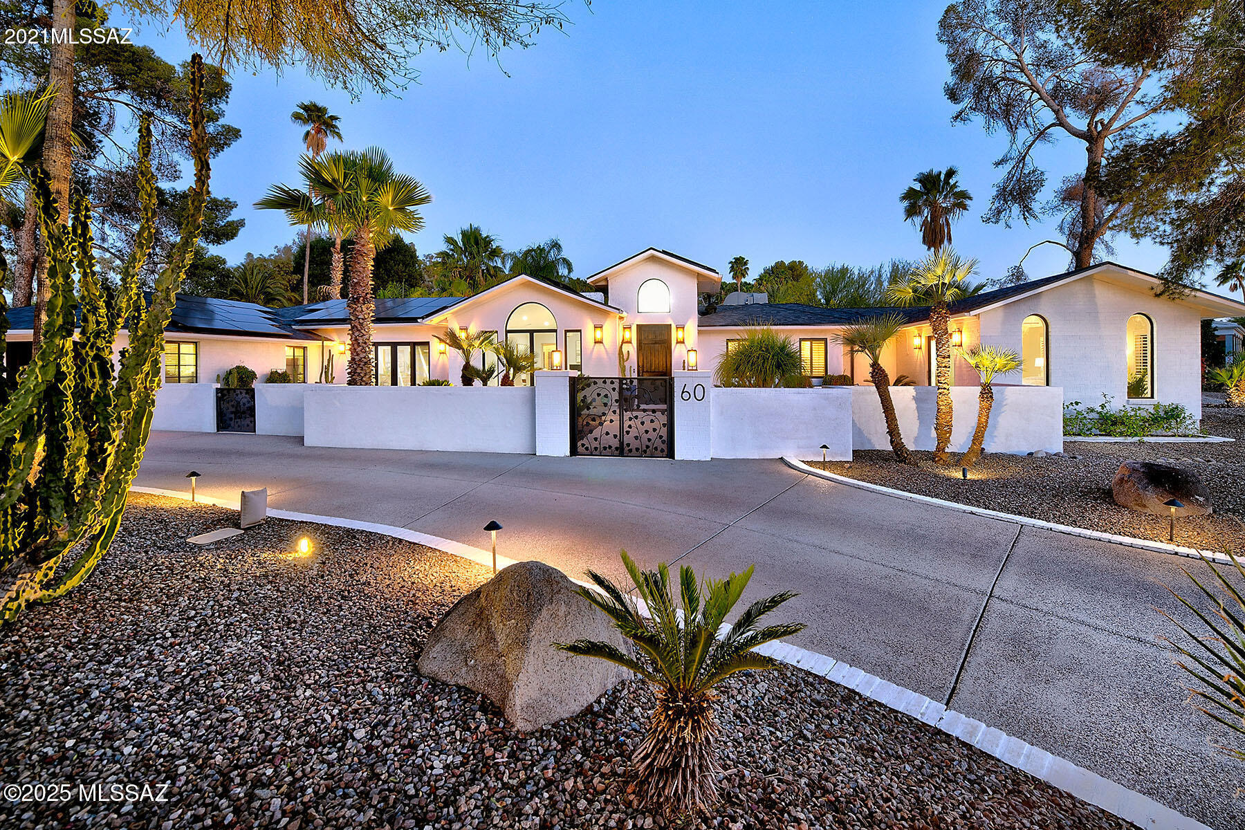 Within the heart of historic El Encanto Estates, this exquisitely updated 1940s Contemporary residence blends timeless architecture with modern luxury upgrades. The heart of the home, a newly reimagined kitchen, showcases a stunning waterfall countertop island, state-of-the-art stainless steel appliances, a breakfast bar for casual dining, and a dedicated eat-in area. A separate butler's pantry enhances functionality with generous storage and prep space, all flowing seamlessly over rich wide-plank wood floors that meet elegant marble in select spaces. Illuminated by soft LED recessed lighting and wired for surround sound, the home offers an inviting and spacious layout. The formal living and dining rooms, and a cozy fireplace, set the stage for refined entertaining, while a separate family room provides a more relaxed setting. The primary suite is a nice retreat, generously proportioned and thoughtfully appointed with a luxurious ensuite bath featuring a walk-in shower and a separate soaking tub. Two additional bedrooms share a stylish hall bathroom, and a private guest suite boasts its own ensuite and a walk-in closet, offering comfort and privacy. Every detail has been carefully considered, from the newer roof and owned solar system to the beautifully reimagined backyard. A resort-inspired back yard, complete with a fully equipped outdoor kitchen, a charming Ramada and outdoor fireplace. The recently Pebble Tec pool, is surrounded by mature Palm trees and lush landscaping walled and very private. Abundant off-street parking and a two-car garage, this residence is both a showpiece and a sanctuary, offering sophisticated desert living in one of Tucson's most treasured neighborhoods. On the National Historic Registrar as a contributing property for owner occupants.