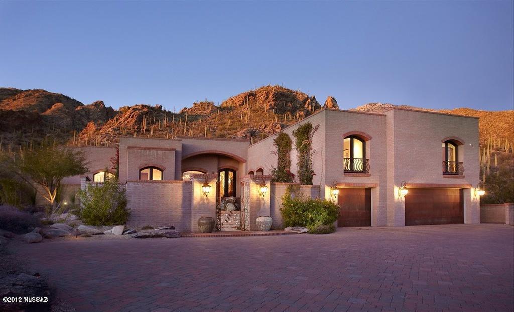 Priced for immediate sale! Behind a manned guard gate built by famed La Quinta, perfectly situated to maximize views while harmoniously blending into an acre + hillside lot, this stunning modern spanish home provides luxurious living with incredible mtn & city views. Charming courtyard entry, formal lvrm w/massive fp w/hand carved stone surround. Dream kitchen open to fam.rm. w/ knotty alder cabinets, granite, island with solid mesquite counter. Viking appliances, 2DW's, lg wine ref, Butlers Pantry. Private mstr suite has his/hers closets, separate laundry, tub & Shower, den/office, 3 guest suites, main laundry rm w/sub zero ref & sink. Media rm Outdoor beautiful negative edge pool, spa, grill and covered entertaining area and large patch of low care turf. Master and main home l