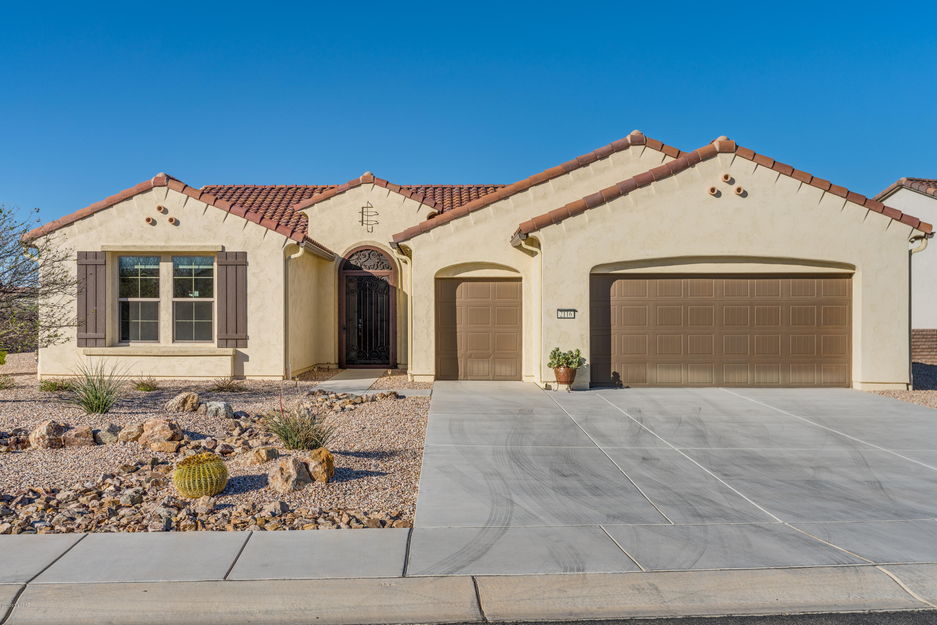 SPECTACULAR VIEWS sunrise, sunset & mountain views from this south facing rear patio that is adjacent to a wash.  The wash affords extra privacy, while enjoying desert wildlife (4' screened fence).    Light & bright, this split floor plan has two en suite bedrooms, a half bath, a den and a laundry with a DREAM CRAFT room.  Generous kitchen w/stainless steel appliances (convection wall and microwave ovens), gas 5 burner range opens to living room and dining room, all w/views of the wash & mountains.  Tile throughout except new carptet in master bedroom (February, 2020).Master en suite has views of mountains & a generous master bath with dual sinks, custom walk in shower & generous walk in master closet.   Guest bedroom also has an en suite with tile floors & walk-in closet. 2.5 Car Garage. Generous den and a bonus craft/laundry room.  2.5 car garage.