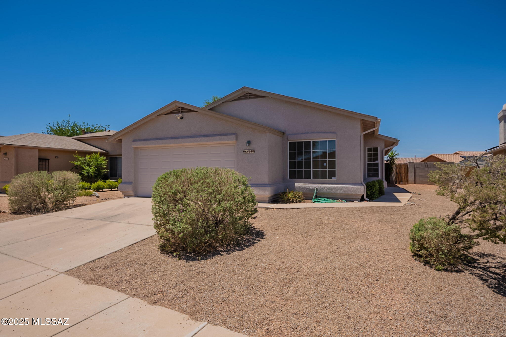 New carpet! New paint! Live near the neighborhood park! 4 bedroom/2 bath move-in ready home has a split bedroom plan with open concept floorplan and high ceilings throughout. There is a  covered patio and block walled yard with a peak of the Catalina Mountains. The roof is approximately four years old, the HVAC is approximately six years old. The kitchen has a gas stove, microwave, garbage disposal, dishwasher, and refrigerator. Walk through the home with a Zillow 3D tour.