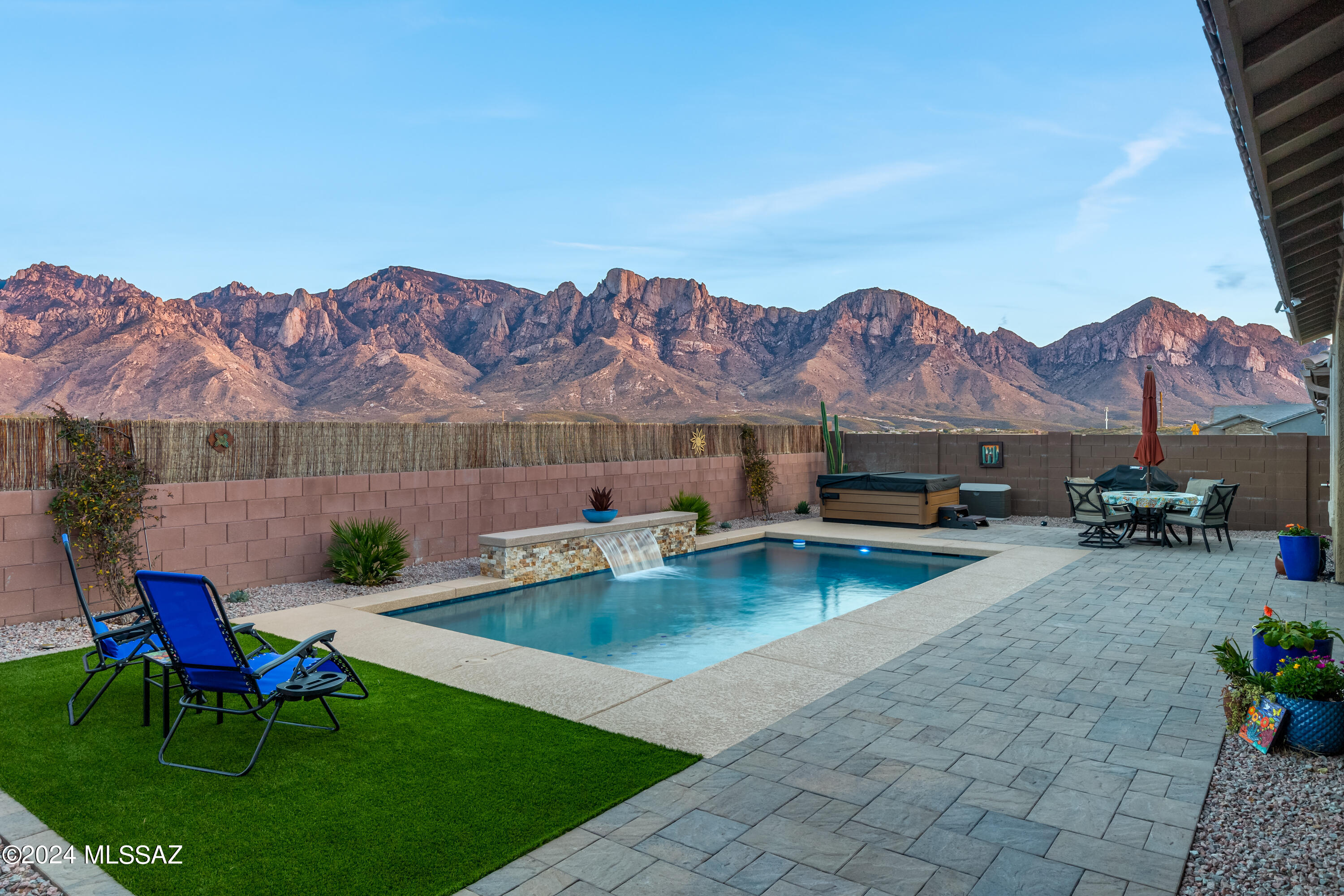 Unobstructed Catalina Mountain views throughout this Beautiful Home. This Home has 4 Bedrooms, 2 1/2 Bathrooms, 2 car garage with 4' Extension. Custom Tile flooring except in Bedrooms, Gourmet Kitchen with Large Island, 42'' Upgraded Cabinets, Stainless Steel Appliances, and Oversized Pantry. Open Greatroom with custom Fireplace and Entertainment Center, Double Sliding Doors to Covered Patio with Views of the Catalina Mountains. Professionally Landscaped Backyard, Pool with waterfalls, Hot tub, Turf, and Pavers. No one behind the property, but the Gorgeous Catalina Mountains. Solar and Water filtration system too! Many more upgrades under documents.