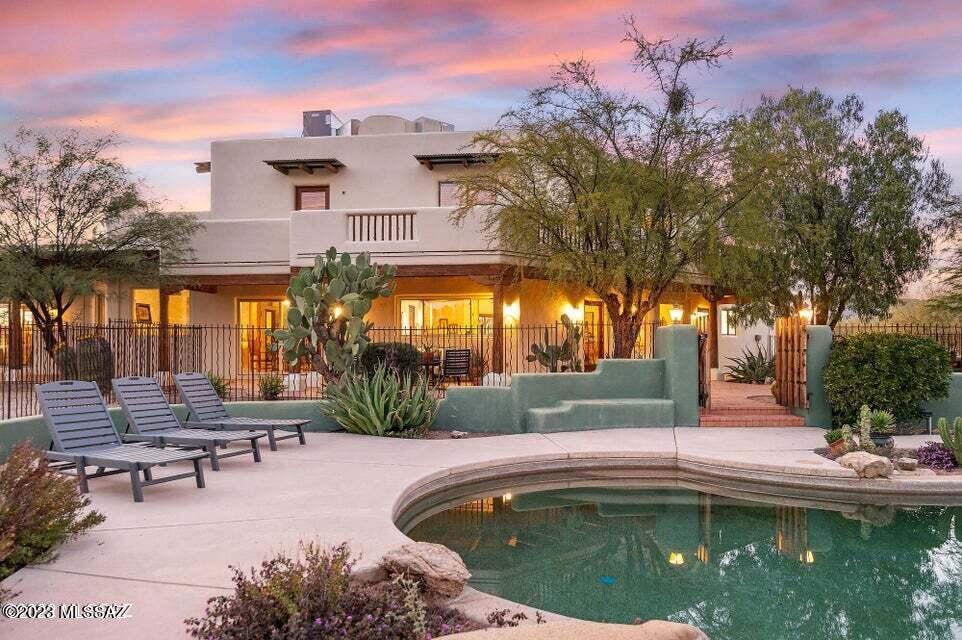 This Equestrian listing provides authentic southwestern serenity while offering the additional amenities of life within a community and close proximity to a hospital , schools, plus Oro Valley restaurants and shopping.
The 7.38 acres rests securely within La Cholla Airpark ; known for its exclusive community and private aircraft facilities. The property has an extensive covered riding arena which was born of a dream to share activities and provide year round use, unencumbered by weather. It's versatility offers endless possibilities for the property owner, including, but not limited to, a main home and separate guest quarters with large open space, great for Clinic discussions or briefings before and after attending activities in the arena. Or simply a fully functional guest house for an additional  caretaker or family member, of any age, to occupy.
The primary residence has a very open floor plan downstairs, including the master suite. The home displays Santa Fe style , rich with character and detail, coupled with panoramic views of the Catalina Mountains. The large fireplace, abundant windows and wood beamed ceilings imbue the home with a unique aesthetic which is rustic yet refined. Talavera tile, brushed finished woodwork and terracotta flooring throughout.
The upstairs offers two additional bedrooms with Jack & Jill bathrooms and a common area which has been used as a reading nook and an additional office space.
Custom designed, very secure, wrought iron fencing surrounds the back yard and both side yards . This insures protection as well as separated areas for both dogs and homeowners, without compromising visitors or deliveries .
Thoughtfully designed outdoor spaces make this a nature lovers secluded haven.
Native vegetation and Saguaros lead to the private guest house . Amenities include a full kitchen, laundry, bedroom, full bathroom and a bonus room which could accommodate hobbies, meetings, an art studio or other gathering space.
A short stroll from the guest house leads to the custom built covered equestrian facility. Two different sets of lighting are present for brighter or dimmer coverage at night, leaving a fully functional situation at all times.
Five stalls are attached to the arena, with shelter over one half of each stall space and an extended section of space uncovered. This year round, day and night , covered equestrian set up is a rare find and could accommodate other interests or activities if desired. This riding arena doubles as a turnout when not in use for schooling and there is ample space to be used for dressage or other purposes behind the covered arena.
Two additional rooms are fully enclosed for a variety of purposes. One includes bathroom facilities and accommodates storage and the other is generally for tack, supplies and feeds. Additionally, there is a wash rack proving hot and cold water for grooming and bathing needs. Feeders are mounted to the wall of each stall and each stall has a water faucet outside of it to make filling waterers easy .
This secluded horse property, just minutes from trail access and so close to Oro Valley makes it irresistible.
