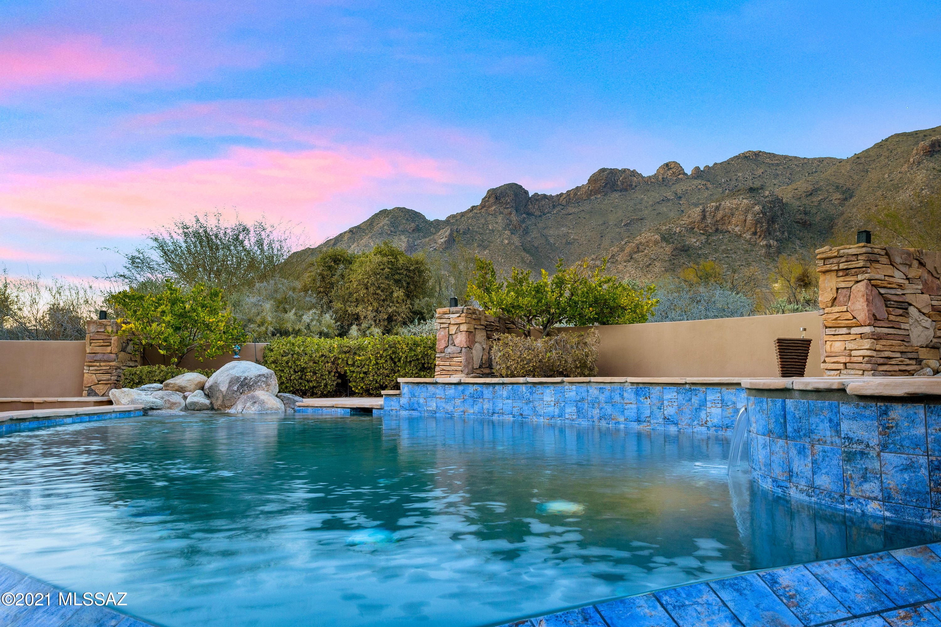 Pima Canyon contemporary home w/ UNOBSTRUCTED CATALINA VIEWS! Exemplary display of renowned architect Kevin Howard & designed by Lori Carroll. Stunning private lot that beautifully blends a forward thinking design while integrating the magical backdrop of the Sonoran desert = PRIVACY! Enter & DAZZLED by the soaring floor to ceiling windows, curved clerestory windows  w/ a touch of warm stone for fireplace. Stone flooring is timeless & chosen for the ease of care & desert living. Creative open floor plan blends a combination of easy flow w/ walls soft and curved but allow for delineation of rooms. The Great Room just got a huge entertainment facelift to a new 85'' TV & fully integrated sound system. 4 Beds/5 Baths/ 3 car garage + Huge sky deck. New pebble tec pool & spa.  Prof Photos coming