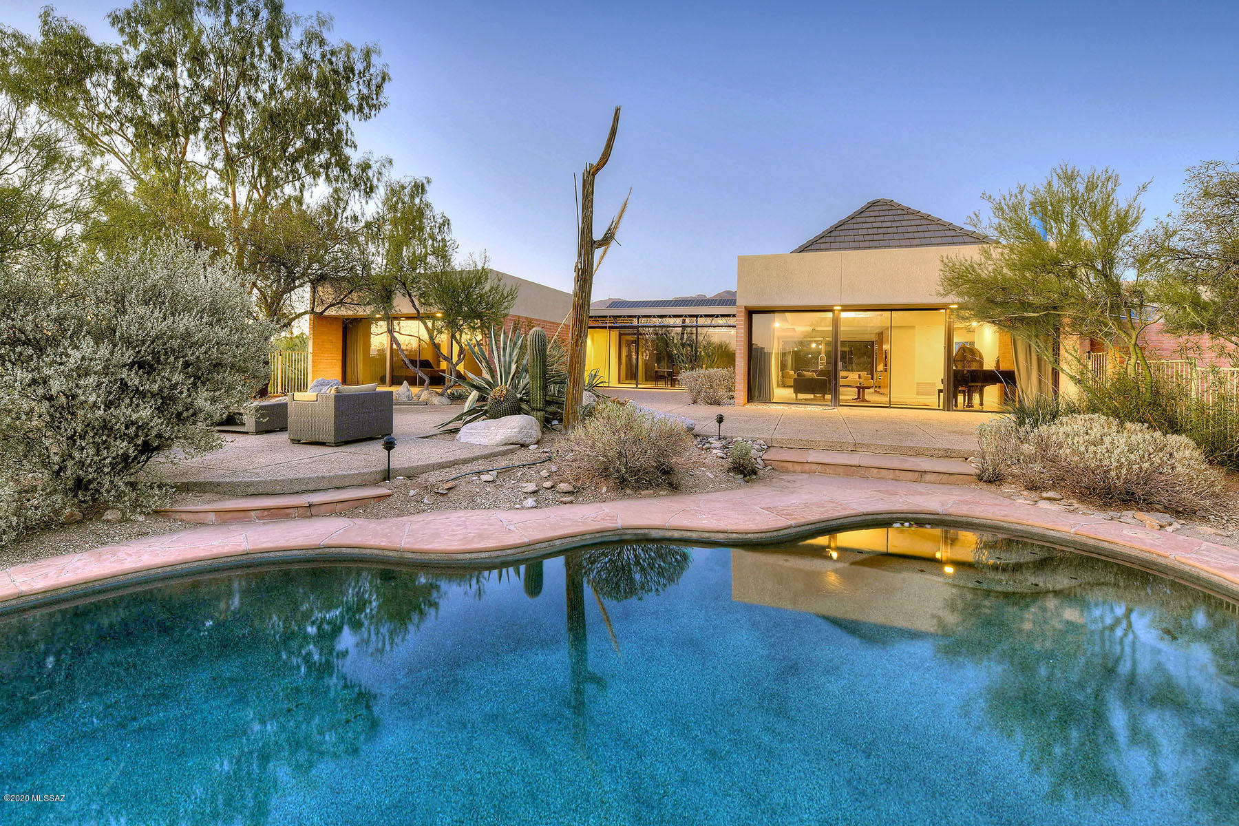 Charming brick & glass contemporary home designed by architect  Robert Swain is a hidden treasure on 2 acres in Catalina Foothills Est.#5.  Beautifully situated to capture mt views, this exceptional home encompasses 3339 sq.ft. w/open floor plan featuring a living rm w/ fireplace & high vaulted ceilings , family rm, dining rm, remodeled kitchen w/ new cabinets , granite & quartz countertops ,stainless steel Miele appliances, gas range, oven, espresso machine, dishwasher , sub zero,  bkfst area, concrete flrs thruout, 3 BR's and 2- 1/2 BA's including mstr w/ sitting area, granite countertops, walk in closet & priv patio. Enjoy bkyd w/ pool, patios , mature trees, mt, city & sunset views, oversized 2 car gar. Hse has solar owned, not leased, Dist .16 schls. Flr pln under photos/virtual tour
