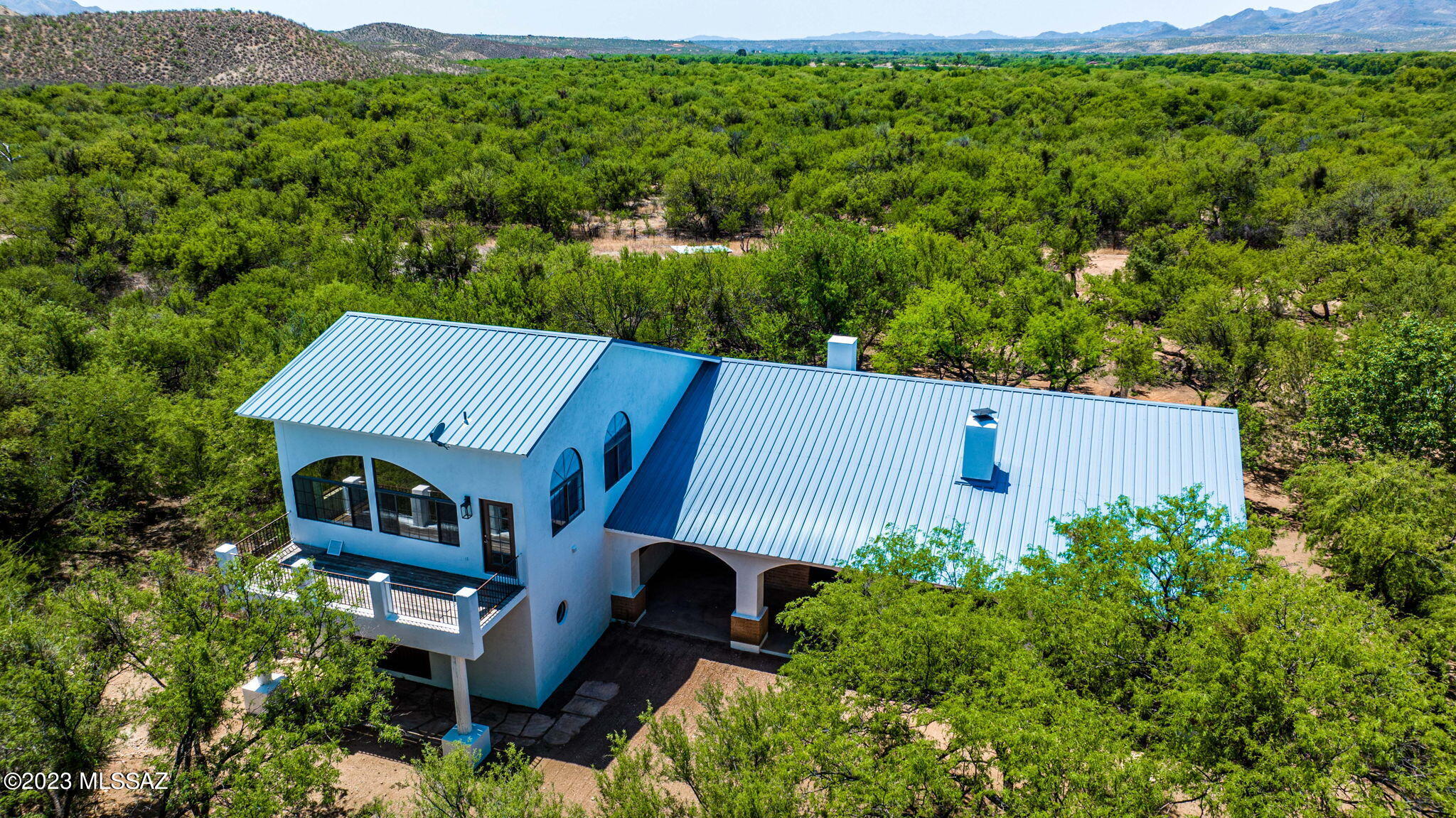 Beautifully remodeled home nestled among mature mesquite trees east of the Santa Cruz River.  With access via the Tubac Bridge, this property is only a few minutes from the renowned four diamond Tubac Golf Resort and the Historic Artisan Village of Tubac voted by USA Today as the number one small artist community in the United States. This 3 bedroom 3.5 bath home features over 4000 square feet of living space with a large wrap around porch in the front and a very open and light reconfigured floorplan. The home has just been remodeled and is a ''open canvas'' waiting for you to apply your personal touches.  There is also a separate garage/work shop on the property for projects or storage.  With NO HOA, your own well and the ability to have livestock and horses, the possibilities are endles