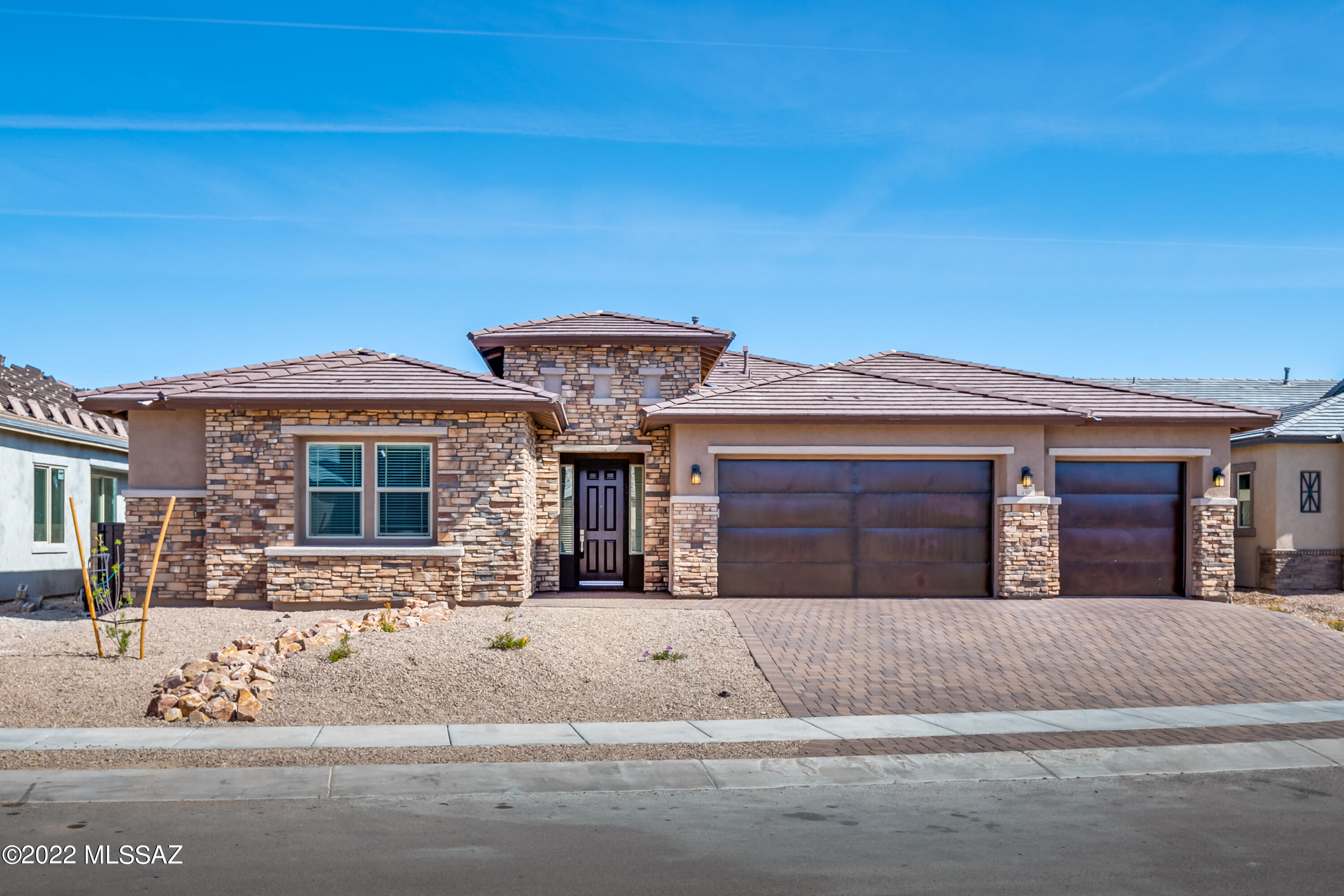 Better than new as it's MOVE IN READY! This Brand-new Richmond American Built 3,140sf, 3BR/2½BA+den single-story home in Rancho Vistoso-Oro Valley has over $150,000 in upgrades. Instant hot water circulation pump, Chemical/Salt-free water softener, State of the art audio/video system, custom closets, upgraded lighting, wood-look porcelain tile floors, remote sunscreen on patio & more. Kitchen has GE Monogram stainless appliances: 36'' gas cooktop, wall oven & microwave oven. Quartz counters, tile backsplash, stylish navy cabinetry, farmhouse sink, large island w/seating, & casual dining area. Butler's pantry has prep sink, under counter beverage refrigerator & large pantry. Formal dining room has coffered ceiling. Great room has fireplace. The master suite includes 2 walk-in closets & private bath w/double sinks in vanity, soaking tub & separate shower w/glass door. The exterior features stacked-stone front & paver stone driveway. 3-Car garage w/rustic finish doors. Ideal location near parks, Honey Bee Canyon, walking & hiking trails, biking, shopping & restaurants & adjacent to the 6.2-mile, 8-foot-wide path through the Vistoso Nature Preserve.