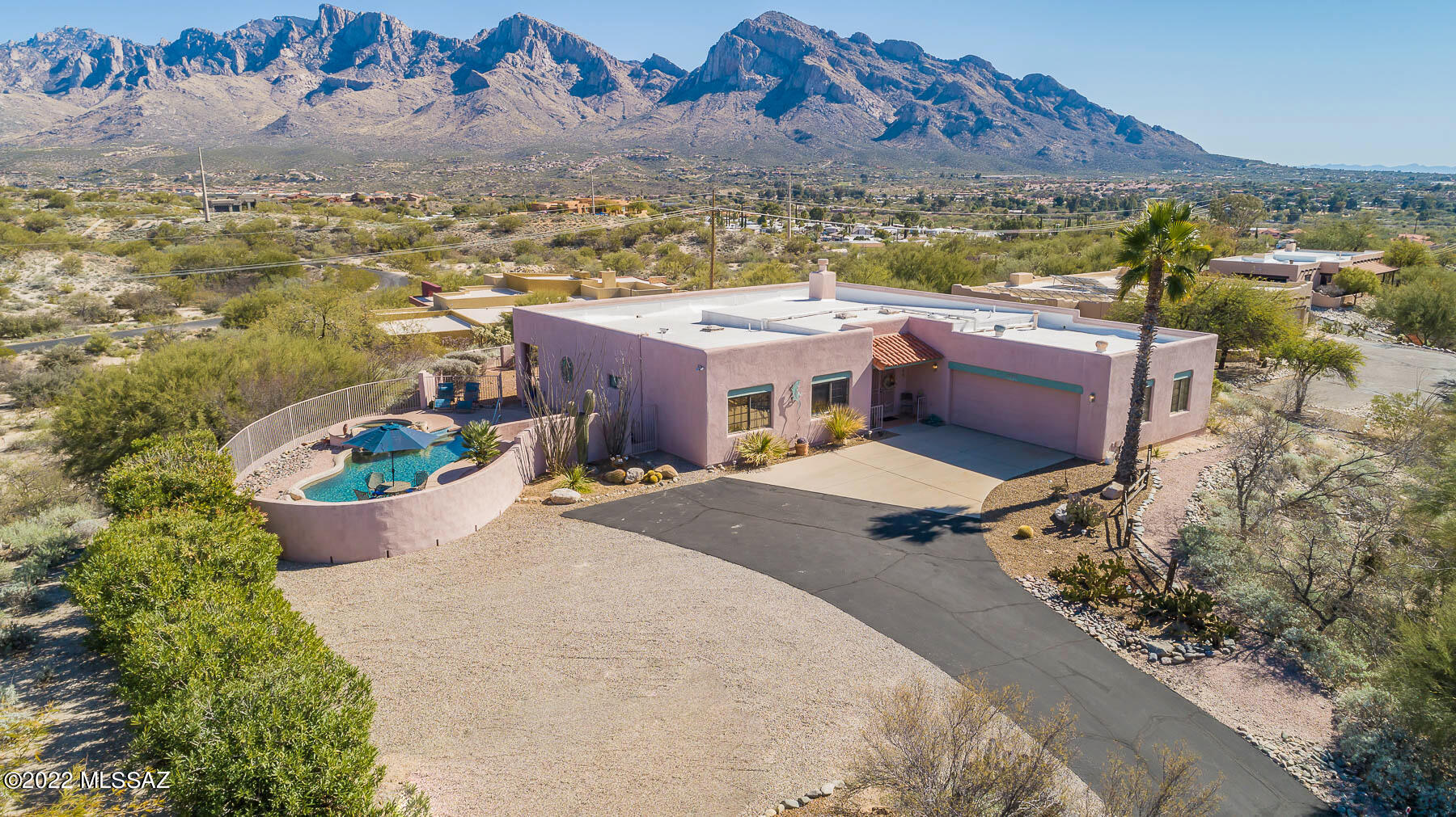 Ridge top home, all one level with sweeping panoramic Mt. Lemmon to Pusch Ridge views in the heart of Oro Valley within walking distance to Naranji Park. Split 3/2 floorplan. Great covered deck that runs the length of the house and leads to a private pool and spa area.  Situated on over a 1 acre lot there is room to expand and make your own improvements and add your personal touch..  Current owner has cared for and lovingly maintained the property for 30 years. They have replacing the poly pipes, painting the exterior, recoating the roof and resealing the driveway numerous times. Most recently some pool equipment, the AC and water heater were replaced..  Oversized two car garage with multiple built-in storage and workbench areas
