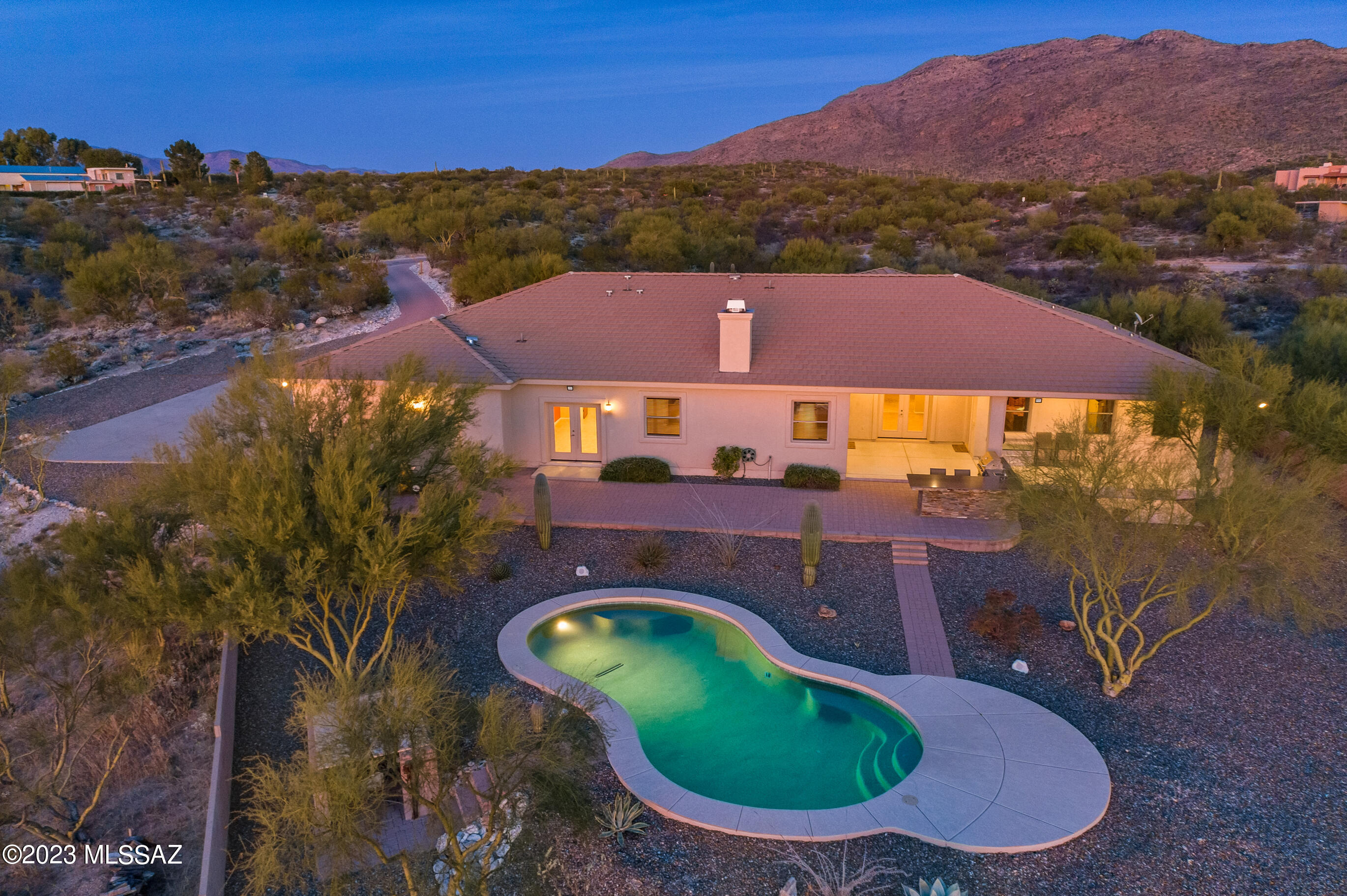 PANORAMIC MOUNTAIN, SUNSET & SUNRISE VIEWS!! PRIVACY GALORE WITH A BEAUTIFUL BACKYARD DESERT OASIS & SPARKLING POOL! Situated on 3.7 acres, this 3308 sq ft custom home (4BR/3BA/Den) sits at the base of the Rincon Mountains & right across from Saguaro Nat'l Park East. All of your guests will love hanging out in the expansive Great Room & Huge Kitchen complete with a Double Oven, Granite Counters, Cherry Cabinets, Breakfast Bar/Island, Built-In Desk, Wood Burning Fireplace & Built-In Buffet. Large Bedrooms, plus an extra Den/Office gives everyone space & privacy. The backyard of your dreams has custom pavers, multiple sitting areas, fireplaces & BBQ. All of this AND an expanded 4-Car Garage with a 12x12 cooled/heated storage room & Zoned as a Horse Property ! Visit Today & Fall in Love! This beautiful custom home has so many extras! Built with insulated concrete forms complete with a stucco finish you will find an expansive floorplan w/ picturesque views through every window. 10' ceilings throughout. The Kitchen has cherry cabinets, granite counters, double wall ovens, a cooktop, microwave, dishwasher, trash compactor, walk-in pantry, desk, and island. The Family Room/Great Room has a wood-burning fireplace, cherry cabinet built-ins, bookcases, and wired for surround sound. Baths have executive-height cherry cabinets, cultured granite counters, tubs/showers. The Primary Bath has double vanities, a jacuzzi tub & walk-in shower. Primary Bedroom also has a custom walk-in closet with built-in shelves. Dual heat pumps & two 50-gallon water heaters. Re-circulation for hot water. Plumbed & electric ready for a water softener. Batt & blown-in insulation in the attic. Evaporative cooler in the garage; 400 amp electric service. 50 amp welder outlet in storage/workshop room in garage.
