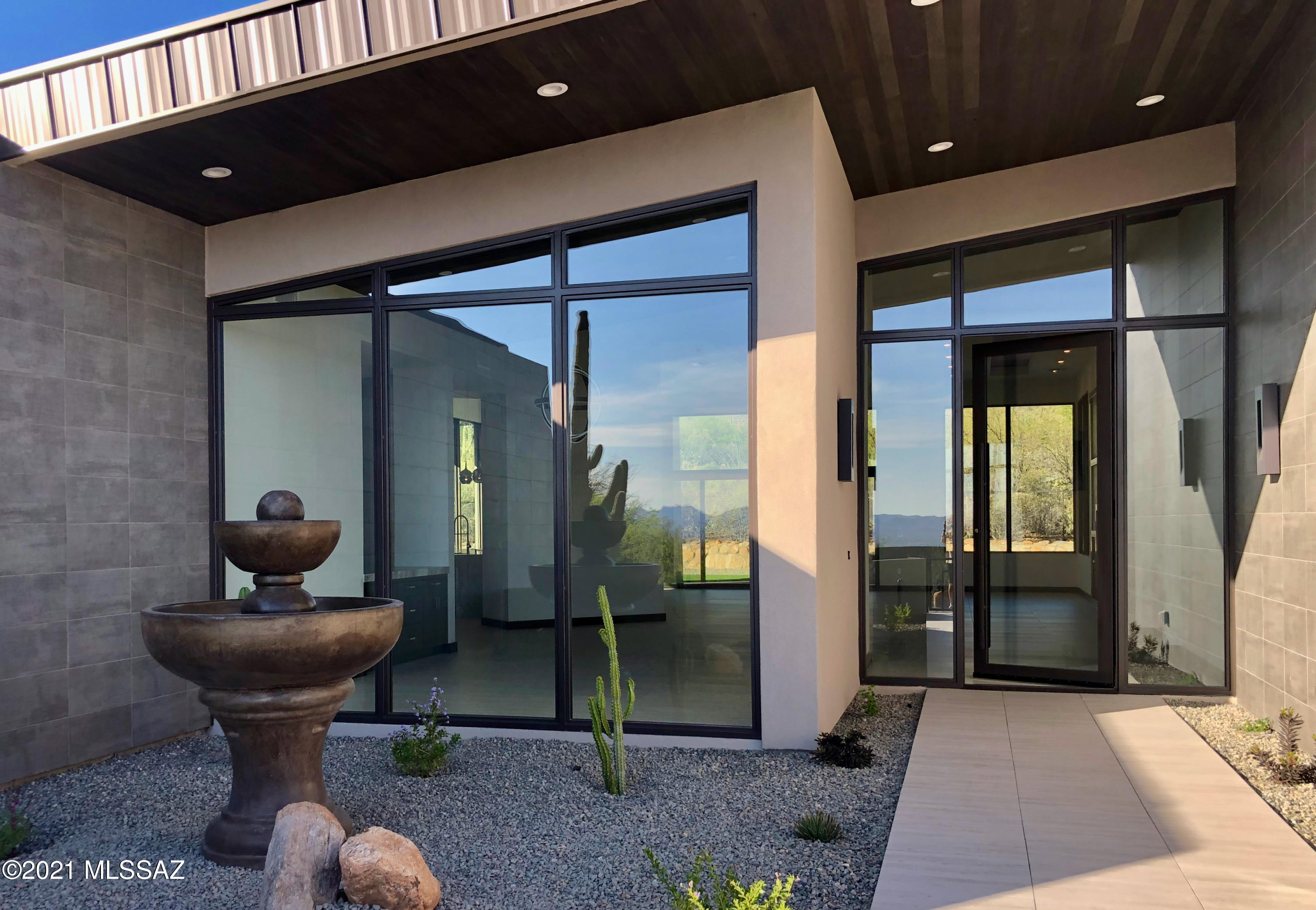This 5,378-sq. ft. stunning desert contemporary is located in the highly-desired Pima Canyon Estates & is the perfect balance of elegance & sophistication. Entertain guests in resort-like backyard w/ built-in BBQ, elevated pool, firepit, & captivating mountain & city views at every turn.