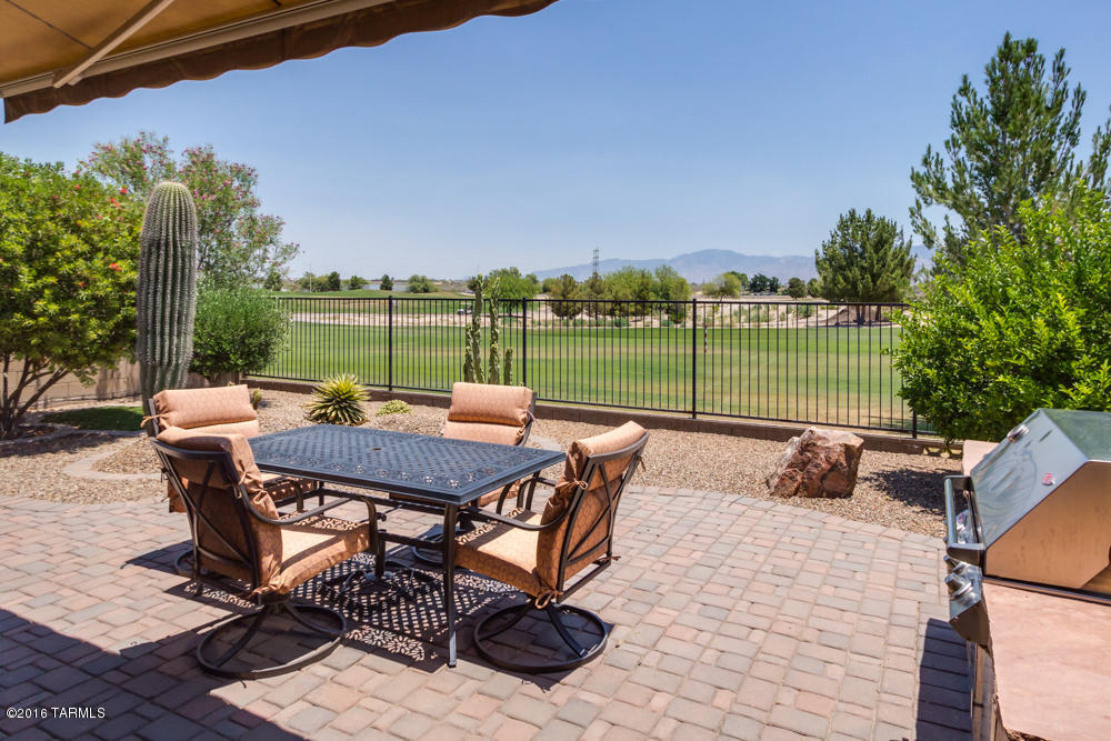 Relaxing Pines golf course living at its finest. Enjoy 9th fairway vistas & Catalina Mtn views from your covered, pavered patio. Built-in gas BBQ w/side burner for stylish outdoor cooking, electric Sunsetter retractable awning (20 yr warranty), mature low care landscaping features a Mexican lime. 12’ great room ceilings, neutral fresh paint, 18” tile floors in the wet areas, decorator ceiling fans throughout. Kitchen offers granite counters, GE appliances, maple cabinets & built in Tech desk. Master features a 100 yr old Midwestern barnwood accent wall, slider to patio. Master walk-in closet recently retro fitted with a California closet style incredible, multi layered storage system. Laundry offers storage closet, garage w/built in storage, plenty of driveway parking.  TEP guarantee h