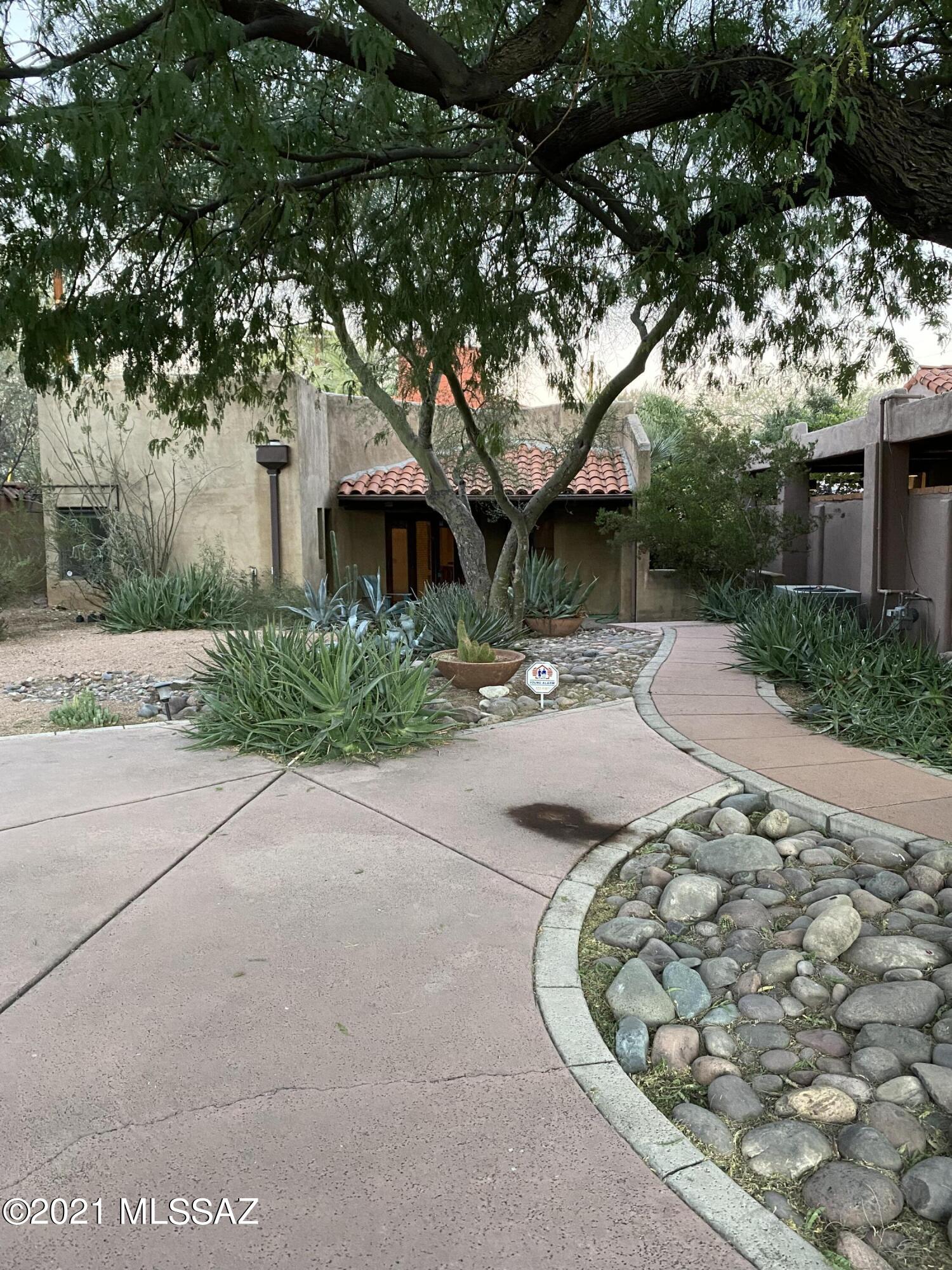 Very Private residence in desirable Sam Hughes. This relaxing home is alive with original Southwest desert touches, Cobalt blue, Terracotta, Earth browns and pale palomino colors welcome you home in this relaxing property.  2 Br 1 & 1/2 Ba. Open floorplan, Kitchen with all appliances. Saltillo Tile flooring and amazing Saguaro Rib Ceilings in main living areas. 2 Fireplaces, Family Room and Master Bedroom.  Cathedral Height rear foyer hallway leads to multi level patio areas. Laundry room includes washer and dryer Solid Plank Beamed ceiling in Master Bath with sunken Tub and walk in shower. Home is set back from street providing an enchanting shaded front entrance yard. Enter the split level rear yard and Covered Carport. Enjoy the privacy. Pet considered with prior Owner approval