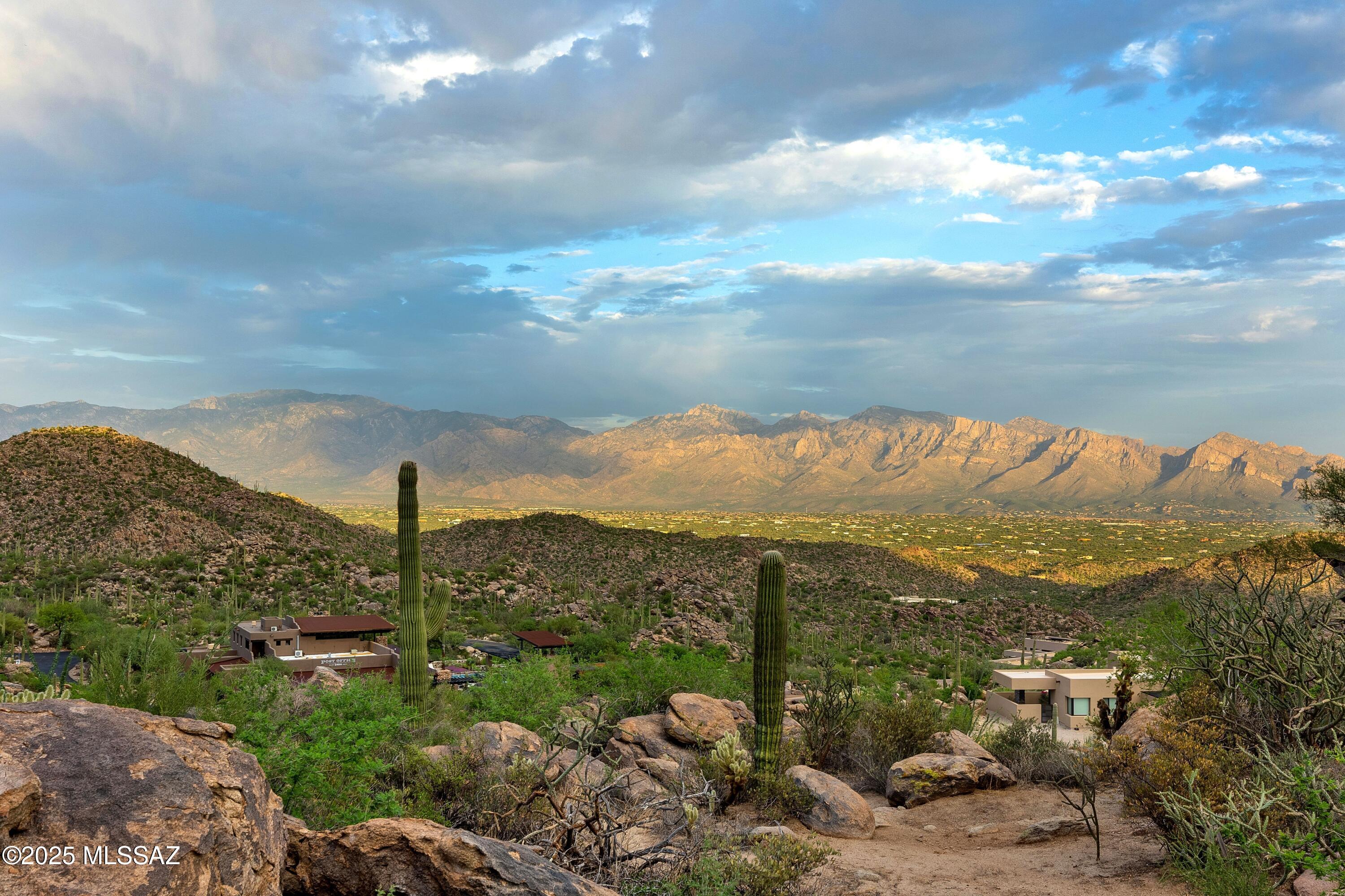 Design your dream estate atop one of the most coveted parcels in Saguaro Ranch—celebrated for its iconic tunnel entrance and architecturally bold residences. This elevated lot boasts uninterrupted views of the Catalina Mountains, sparkling city lights, and sweeping rock formations.
Nestled in pristine desert for maximum privacy, the homesite offers paved road access, underground utilities, and flexible design potential. For those seeking inspiration, a stunning architectural plan by Drewett Works—renowned for its exceptional design work—has already been approved. Floor plans and Renderings can be found in the documents section, providing a head start toward realizing a truly custom desert retreat.
Call listing agent to schedule a showing.