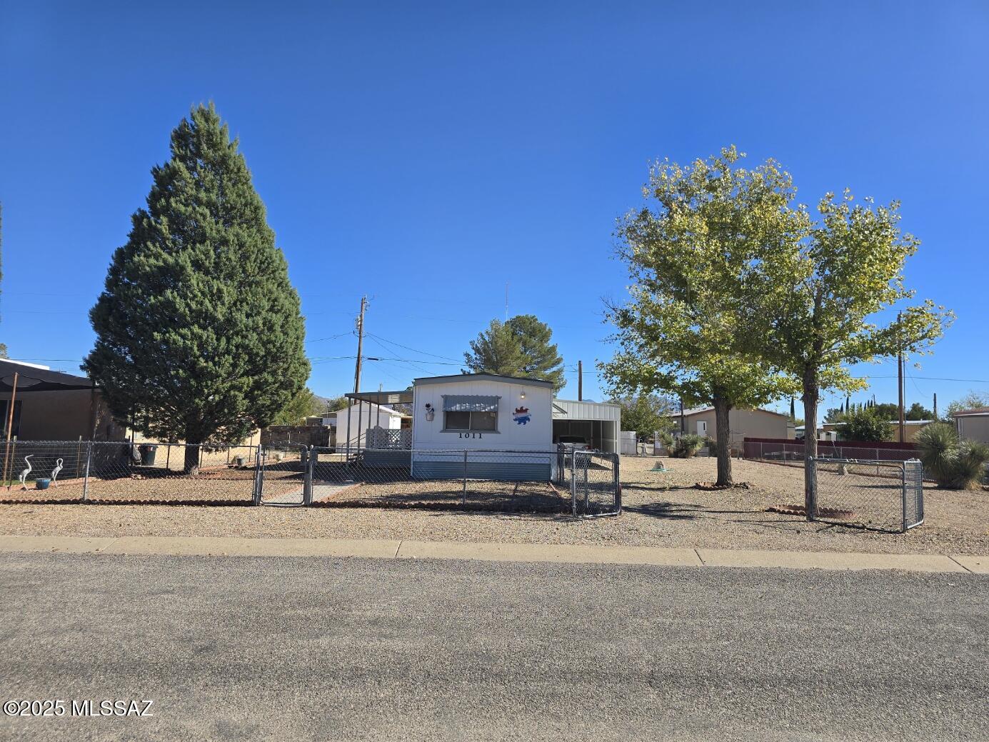 Immaculate 3 bedroom 2 bathroom home in the heart of Willcox. This home has been extremely well maintained. Has a metal roof and is on a lot and a half, plenty of room to build a shop/garage or ad an aux tiny home living space. This property is completely fenced with a covered car port and a covered front porch. Mature trees for shade and gravel landscaping for low maintenance. You don't want to miss out on this property.