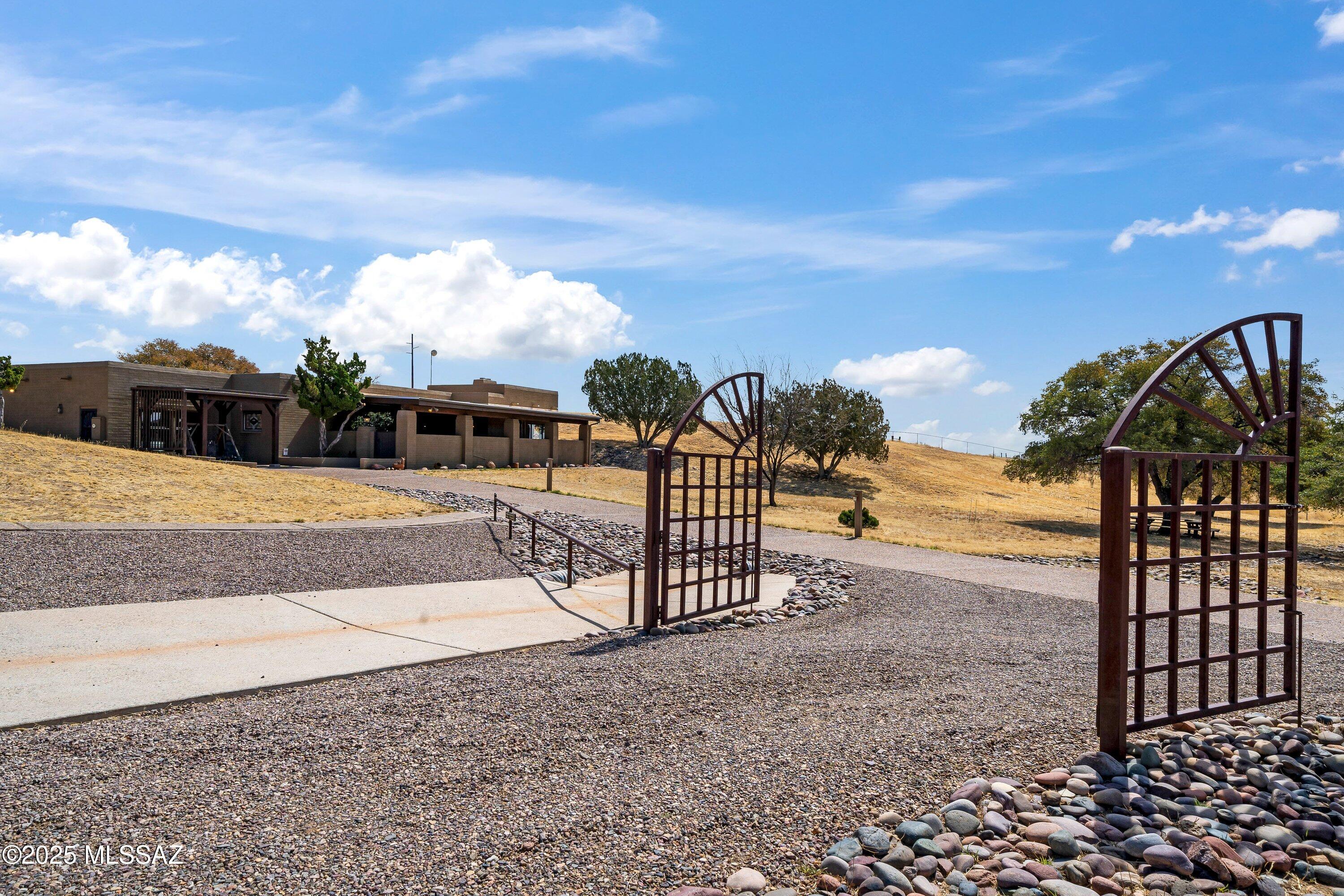 Estate Sale Property, Make an OFFER! A RARE find in MAGICAL parklike setting! Borders  Nat'l Forest on 2 sides w/ ride-out access!  Main Home, Guest Casita & Bunk house/Caretaker QRTRS all constructed of solid Stri-Face brick block. Gorgeous pristine grounds in a Private gated Ranch Setting on north side of Sonoita w/dramatic Views. Ideal as family/corporate Retreat, host Chuckwagon BBQ's, outdoor entertaining venues or Equine activity property w/5 pastures & Forest entry gates to endless riding. Huge block/frame Cov'd Ramada w/picnic benches, Feed storage, 2 block horse stalls & Equip. garage. A Solid Block Const. Two Bdrm Main home worthy of your modern updating investment! Enclosed large patio w/storage stocked w/cast iron cookware! Start living your dream at this impressive property! to appreciate all the finely appointed attributes such as beautiful mature oak dotted countryside, mountain views, exposed aggregate driveways with river run swails, concrete apron, gravel guest parking and perimeter is completely fenced. Tucked away within minutes from the highway yet tranquil and private!  Many tools, equipment and cookware to convey.  This is an "Estate Sale" property with no SPDS available. Property has been well maintained and properly cared for by grounds keeper!