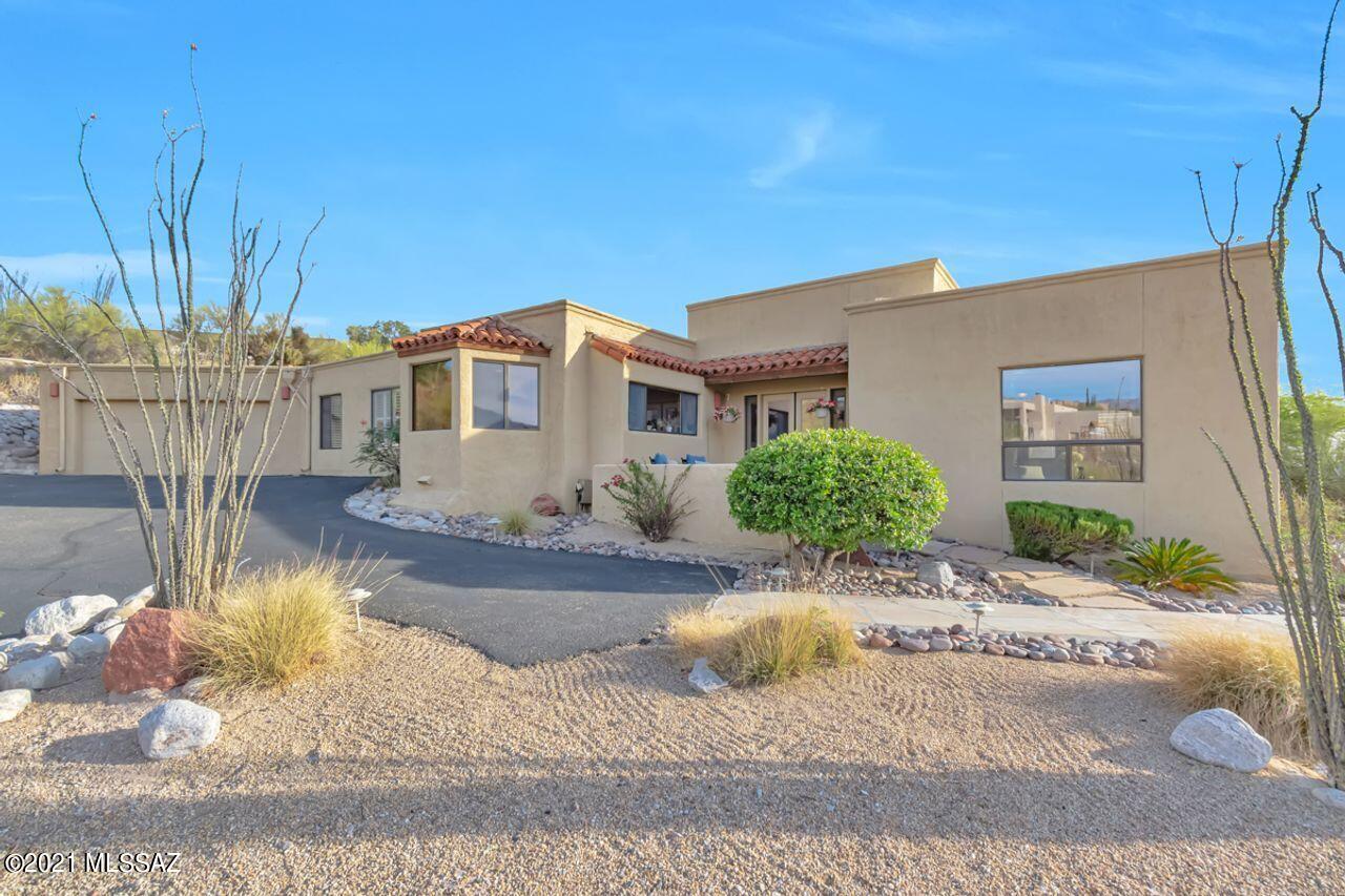 Amazing foothills home with mountain, city and sunset views!  Split plan with En suite guest room plus separate den. Enjoy the warmth of the wood look tile floors, wood shutters, high ceilings with wood beams and the 2 fireplaces. Make sure to see the little patio off of living room to capture the views.   The refreshing pool has a lagoon to relax in and the yard is elevated, perfect for viewing the city and Arizona's sunsets.  The large gourmet kitchen has mountain views from the kitchen window.   The generous main bath has a separate shower and door to the pool. The spacious laundry room leads to a bonus, exercise or craft room. Extra space in the 2-car garage. See HOA information at sunrisevillage.org.  District 16 schools.