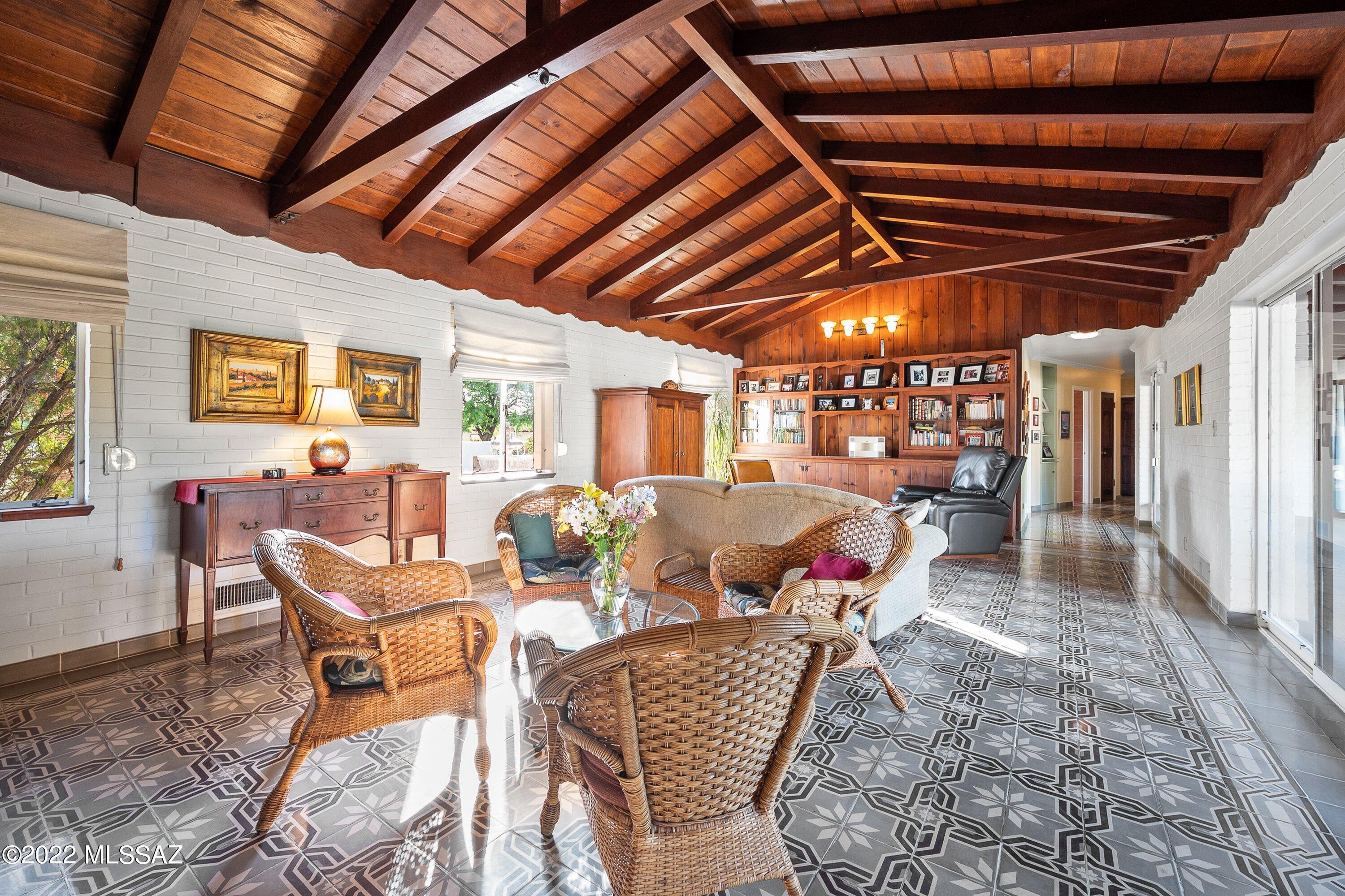 Stunningly beautiful, Joesler-style home near the historic Arizona Inn. Quintessential Mid-Century Tucson: sophisticated & high quality, yet comfortable & inviting. Soaring beamed ceilings. Vintage built-ins. Decorative concrete tiles. Western red cedar kitchen cabinets w/ soapstone counters. Two ovens, including working vintage Thermodor. Wood-burning fireplaces in dining room, living room & patio. Lovely pool & spa w/ water feature. Poolside ramada & bar w/ sink, refrigerator & corrugated roof. Almost half an acre of urban privacy & bliss. Extraordinary upgraded guesthouse has been a thriving Airbnb. Heated & cooled workshop/workout room adjacent to guest house. Contributing property to Catalina Vista National Historic District. Significant property tax savings for owner-occupant.
