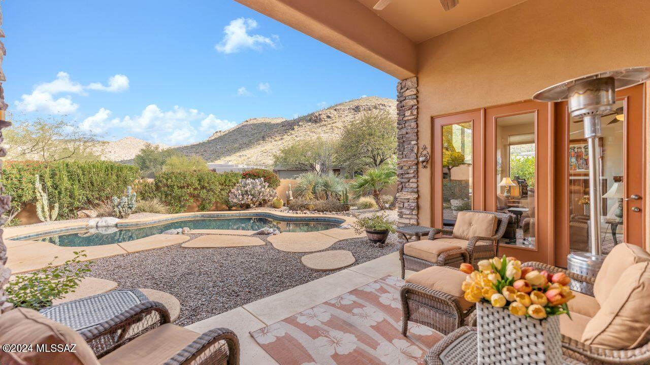 View stunning Tortolitas at your Golf Villa in Dove Mountain/Solana.  Largest former model boast travertine/HDWD/carpet flooring. Remodeled kitchen offers new appliances, quartz island, stacked stone bksplash, granite counters w/white cabinets. Powder room. Primary BDRM has French door to rear covered veranda. Bath offers, travertine tile counters, 6-jet soaking tub/spa, walk-in shower, custom closets. Guest suite #1 & #2 each have their own luxurious bath. Den/office can double as an additional BDRM if needed. Sparkling pebble-tec pool, BBQ & beautiful mature landscaping.  Spacious laundry room leads to extended 2 car garage w/built-in cabinets. Entry CTYD features a wood-burning FRPL. HOA includes front landscaping, pest control, trash, gated entrance and all common area landscaping.