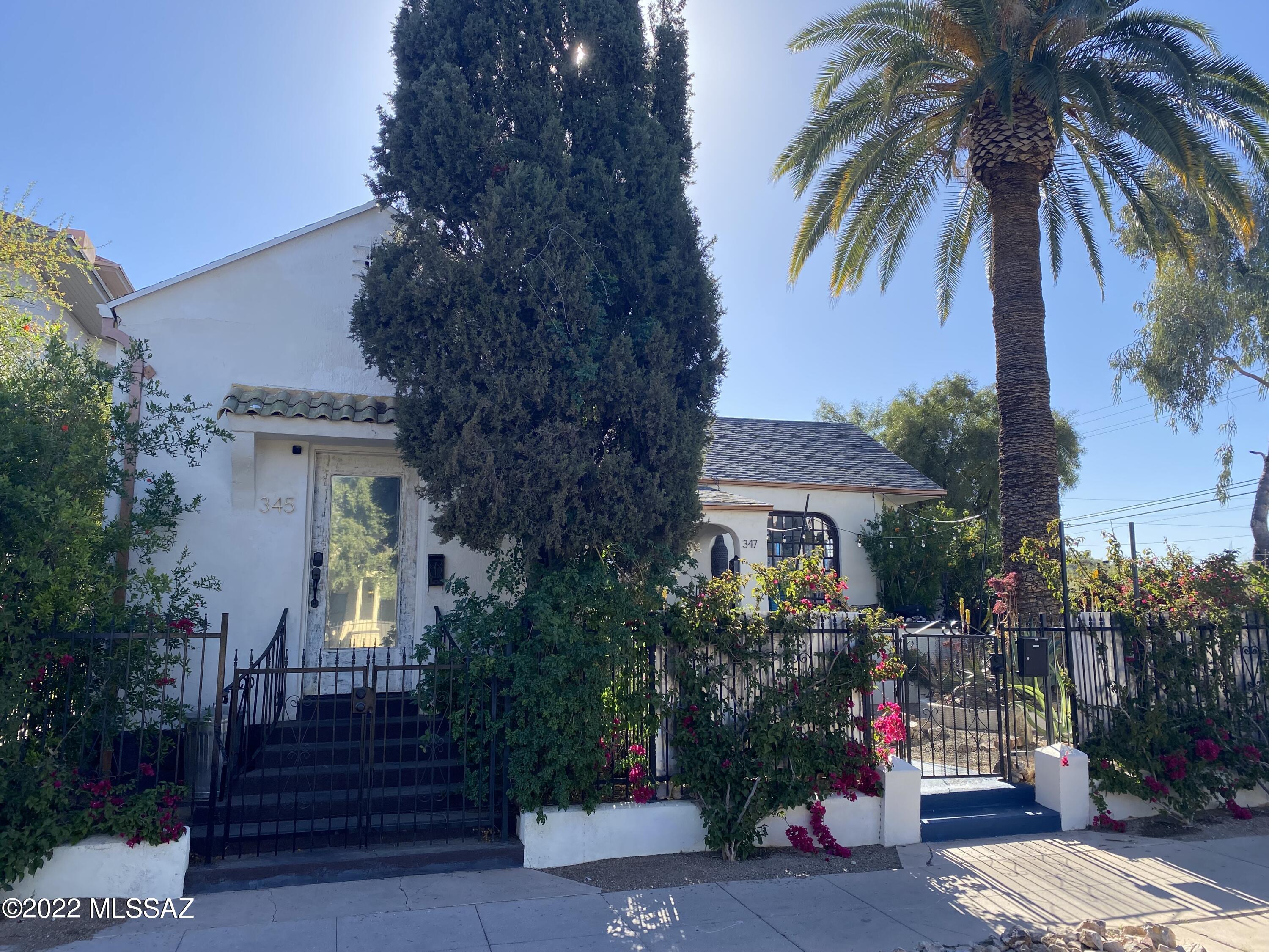 Range price $879,000 to $940,000. Sellers will accept or counter all offers made within the range. One-of-a-kind beautifully restored historic gem built in 1903 w/ a guest house added in 1926. Endless possibilities with C-3 zoning, allowing home business, residential, Airbnb, or a combination of all 3. Corner lot, front courtyard with covered patio. Main house features 3 bedrooms + a office, both bathrooms have refinished clawfoot tubs. Huge great room, open kitchen, plus a dining room. Guest house (successful Airbnb) has its own Street entrance 500 ft.² one bedroom, one bath, a full kitchen w/ a dishwasher. Walkability score of 89 means you can accomplish almost everything without using your detached 2-car garage (could be a home business or the 3rd rental unit). Private backyard will make you forget that you are downtown, plus a side courtyard, for a total of 3 outdoor living spaces. 1 block from the Children's Museum, Armory Park Neighborhood Center, and Cafes. Bike score is a 100.  
Fully restored, light drenched house with spectacular architectural
details. Hardwood floors throughout, high ceilings, picture railings,
wood windows and trim. With 220 rave reviews on AirBnB averaging 4.91 stars, people love the location and the space! The front yard boasts mature succulents for a low water use, yet lush
feel. Desert adapted flowers bloom year round drawing hummingbirds and butterflies to the front patio dining area. From this elevated viewpoint, one can watch the Tucson Parade of Lights, the Tour de Tucson start and finish line and the St Patrick's Day Parade.
Enter through the stained glass front door into the atrium with a
stunning copper leafed ceiling and an art deco wood arch. The palatial living room boasts 7 foot tall palladian windows made of mahogany, a carved marble fireplace and high coved ceilings.
Two bathrooms with gorgeous, fully restored clawfoot bathtubs, real wood beadboard wainscotting and the original penny tile floor. Middle bedroom is being used as a luxe dressing room and the back bedroom features an en suite bathroom with clawfoot tub and exposed brick wall. 
One of the first car garages ever built in Armory Park, it's fully
finished with a whisper quiet mini split system keeping it ice cold in the summer. Color neutral lighting installed making it a perfect
workshop or studio space for an artist.
The back yard is perfect for both private entertaining and your furry friends with its tall brick walls, aluminet shade and brick work covered ground. Both the side and back yards have high quality, artificial grass areas installed with a  zeolite impregnated base for odor control.
Two outdoor eating areas, one on the front patio, the other in the
private side yard surrounded by lush greenery and brilliant pink
blooms. Exposed brick on the exterior wall has been sealed with water repellent nano particle sealant.