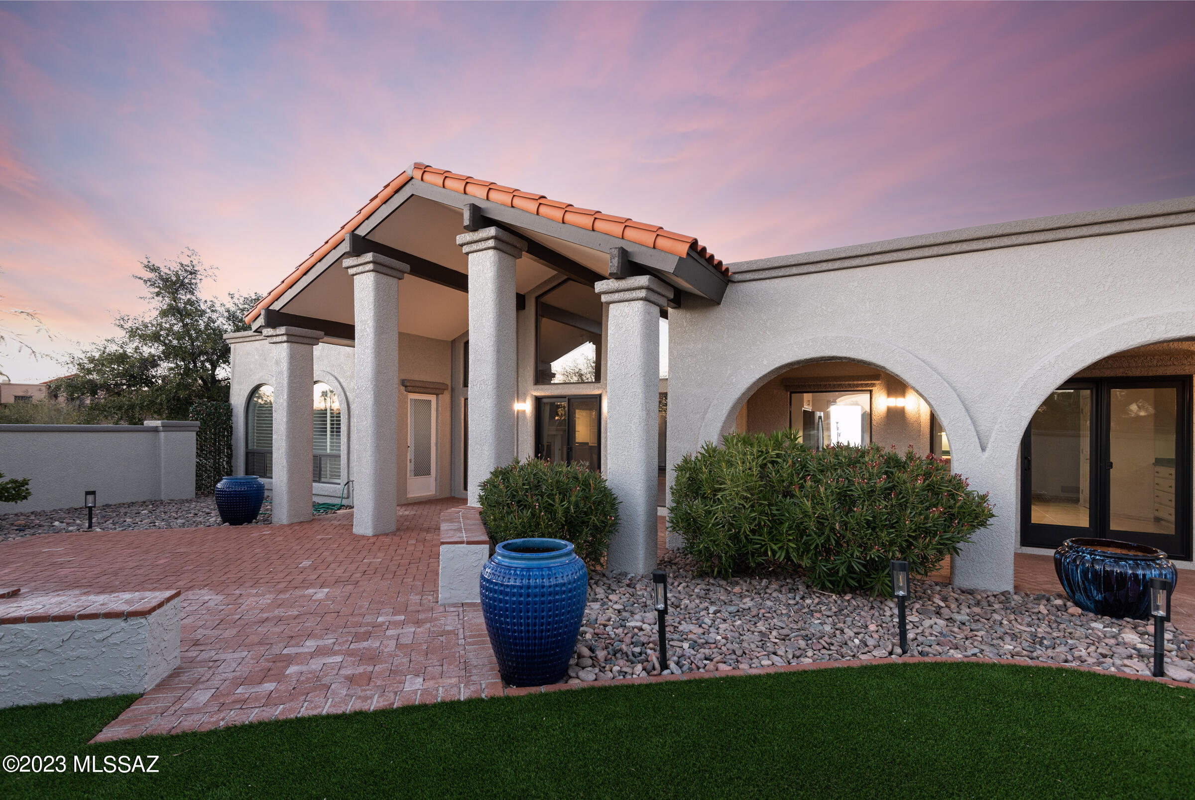 Range Price is $850,000 - $880,000 Take an evening stroll to the patio at North for a cocktail, or a short walk to the Campbell Trailhead for a morning hike from this custom contemporary home on a half-acre lot at the end of a cul-de-sac in this prime location. Walk to Manzanita Elementary School. Situated between La Encantada mall & the border of the Coronado Forest at the top of Campbell Ave, offering unparalleled convenience to the best of everything in Tucson. New, long concrete driveway leads to front courtyard entry w/ mountain views & dramatic portico entry w/ tile roof. Neutral, polished marble flooring w/ custom details Living room/ formal dining  w/ soaring ceilings, wood beams, a fireplace, custom built-ins, & a huge wall of windows that pours natural light into the space.