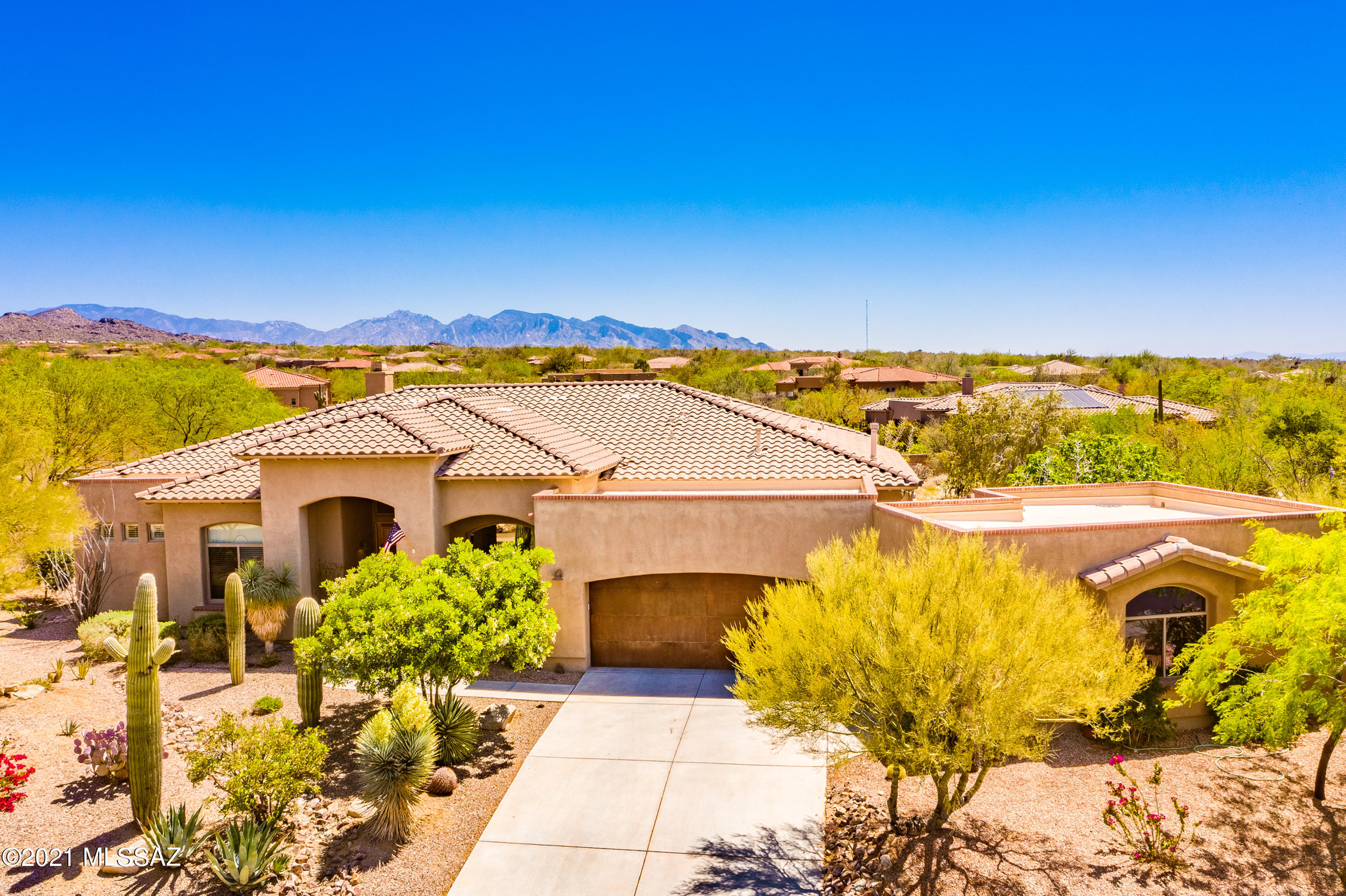 Stunning backyard is a true entertainer's dream. Gated Dos Lagos home features a large front entry porch leads opening to soaring ceilings, and large picture windows highlighting private Catalina Mountain and desert views. Stacked stone fireplace and tv area are open to kitchen w/ breakfast bar, nook, and walk in pantry. Gourmet cook's 6 burner gas Thermador range highlights the well appointed kitchen.  Master bed has bay window, large soaker tub and direct patio / yard access. The split plan has an office/den on master side of the home, w/ 2 beds and private bath on other side. The amazing pool w/bridge over water to private patio, 4 waterfalls, swim up seating and sun deck. Newly installed split HVAC system in 2020, new pool equip. 3.5 car garage can be a casita as well!!!