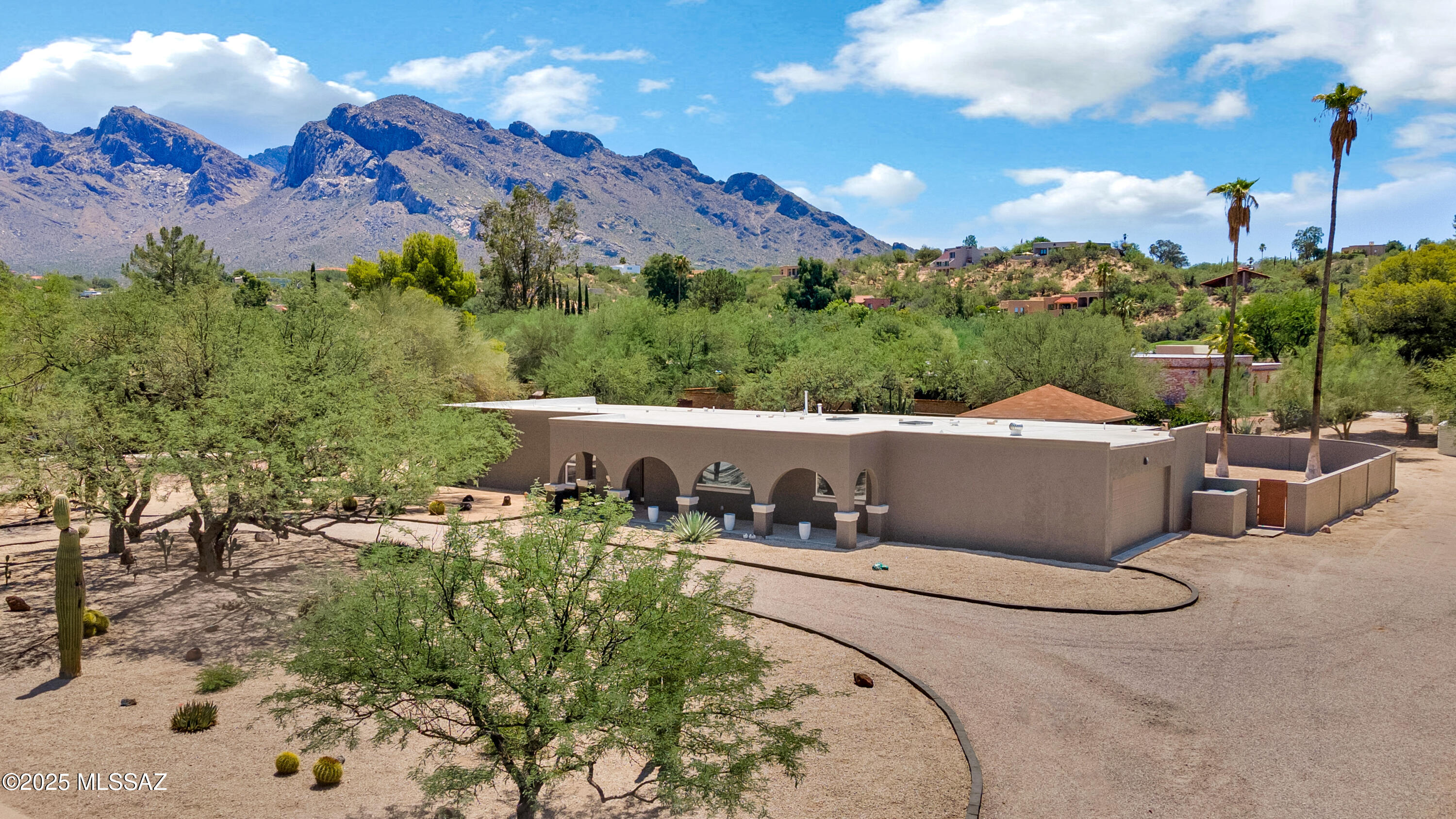Fabulous Oro Valley Estates in the highly coveted Oro Valley Country Club. Beautifully renovated home. Wide open great room floor plan with several entertaining and relaxing spaces, copious windows and skylights which lend to beautiful, bright, open spacious feel. Recent updates include oversized ceramic tile flooring, modern kitchen with stainless steel appliances including a wine cooler, ample cabinet space, center island with farm house sink and Quartz counter tops. Wonderfully updated primary suite with fireplace and spa like bathroom with over-sized walk-in shower and closet. Resort style rear yard boast pool with waterfall, gazebo, low care landscaping and mountain views. Recently painted exterior.