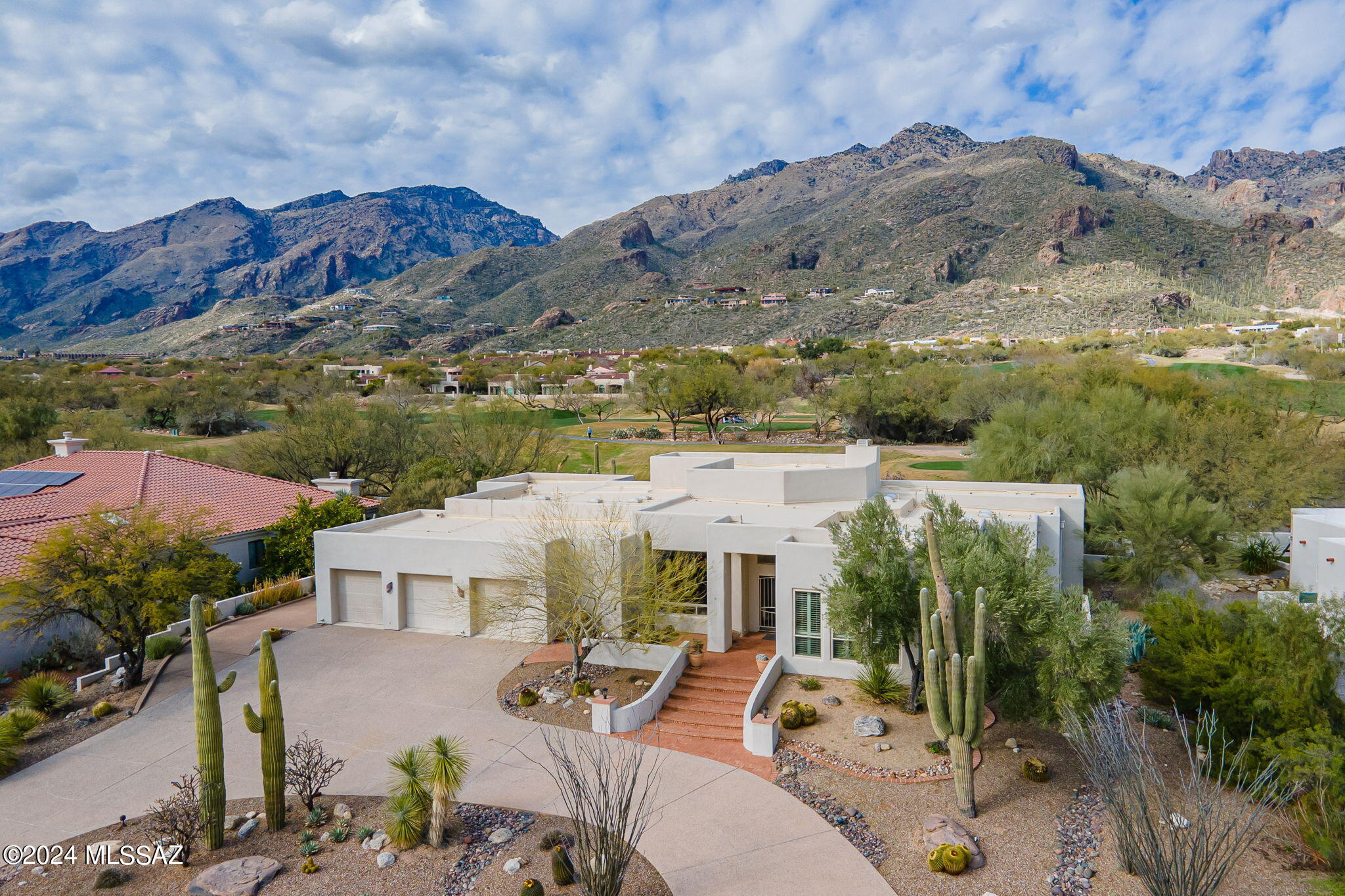 Highly Desirable Single Level 4 Bedroom & 4 Bath Contemporary Home on the Ventana Canyon Golf Course w/ Panoramic Mountain Views. Spacious Open Floor Plan w/ True Great Room Concept Combining Living, Dining, & Kitchen Spaces all w/ Floor To Ceiling Windows Offering Plentiful Natural Light. Fine Features Include: Brick Paver Front Entry w/ Valley Views -  Travertine Floors - Vaulted Ceilings - Island Kitchen w/ Breakfast Bar & Walk in Pantry - Primary Suite w/ Private Sitting Area, Two Walk in Closets, Spa Bath & Separate Shower - Attached Guest Quarters (4th BR) w/Kitchenette, Living Area, Bath, & Private Entrance w/ Parking - Circular Driveway & 3 Bay Garage - No Steps Anywhere - Private Back Patio w/ Built in BBQ, Hot Tub, & Views, Views, Views! This One Won't Last Long.