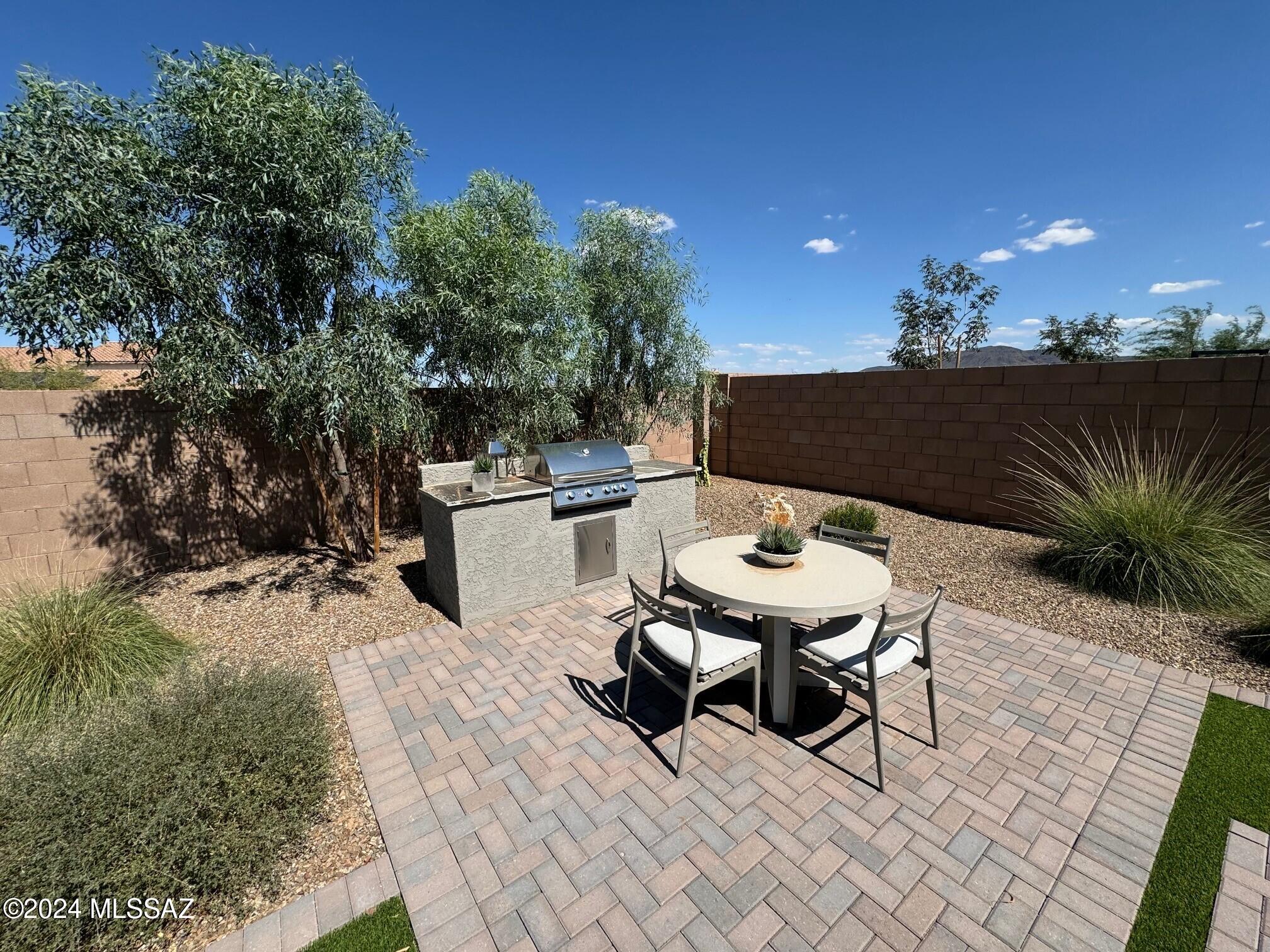 Explore this must-see Juniper model home! Included features: an inviting covered entry, a spacious great room, a well-appointed kitchen boasting quartz countertops and a roomy pantry, an extended covered patio, a lavish primary suite showcasing a generous walk-in closet and a private bath with double sinks, a central laundry, a convenient mudroom and a 2-car garage. This home also offers a ceiling fans and additional windows in select rooms, a solar power package, ceramic tile flooring in several rooms, backyard landscaping and more.
