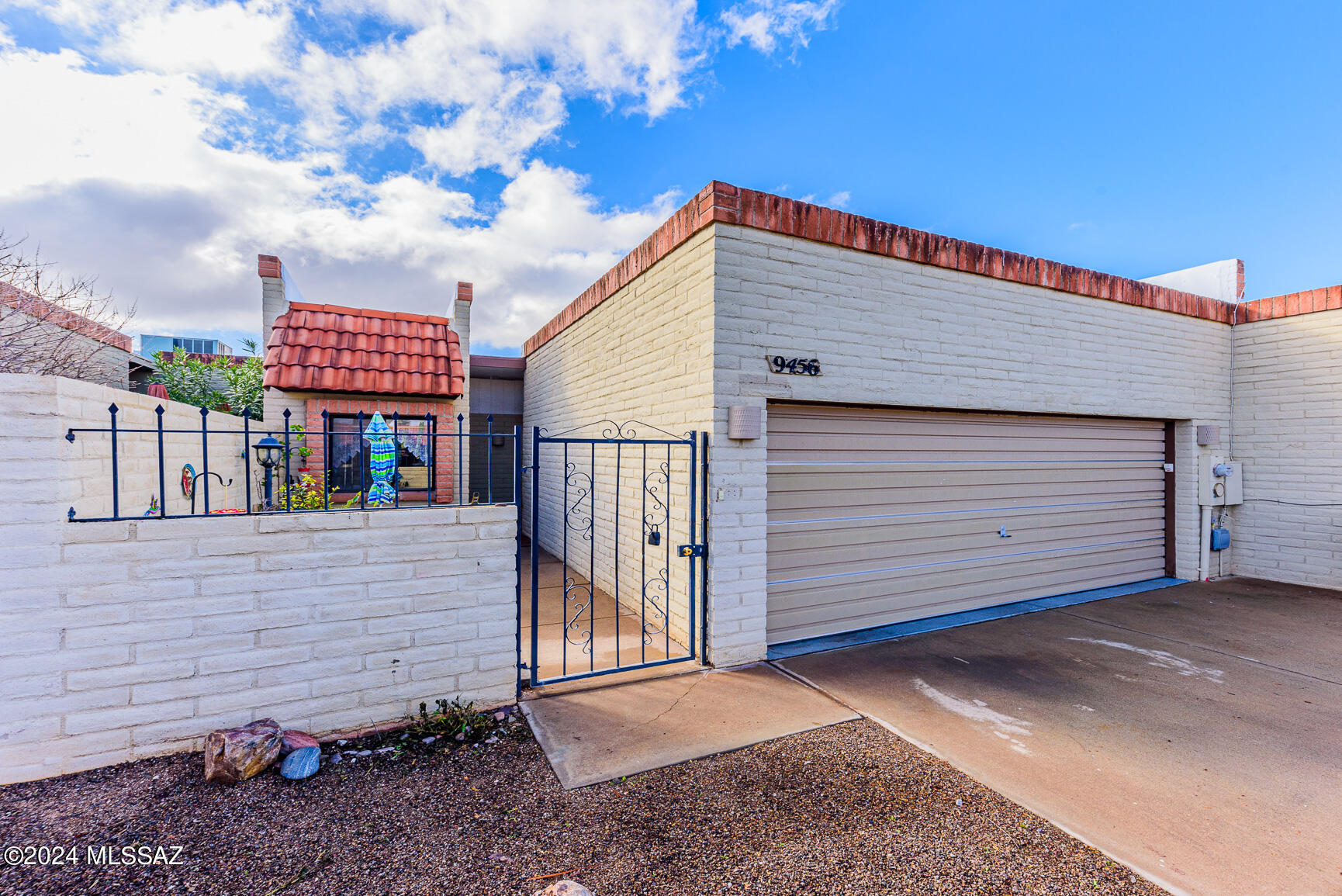 Two Bedroom Two Bath townhome with a large two car garage, gated outdoor foyer entrance and outdoor patio/yard. Located in the heart of Eastern Tucson. This home features tile and laminate flooring throughout. Updated kitchen with stainless appliances and a breakfast nook area. A dining area separating the living area with a pony wall.  Living area features a fireplace and French doors that lead to an Arizona room, a laundry room and backyard/patio area.  Each bedroom is generously sized.  Master bedroom features walk in closet, a large walk in shower and French doors to the Arizona room. Complex features a community pool. One of the owners is a licensed agent.