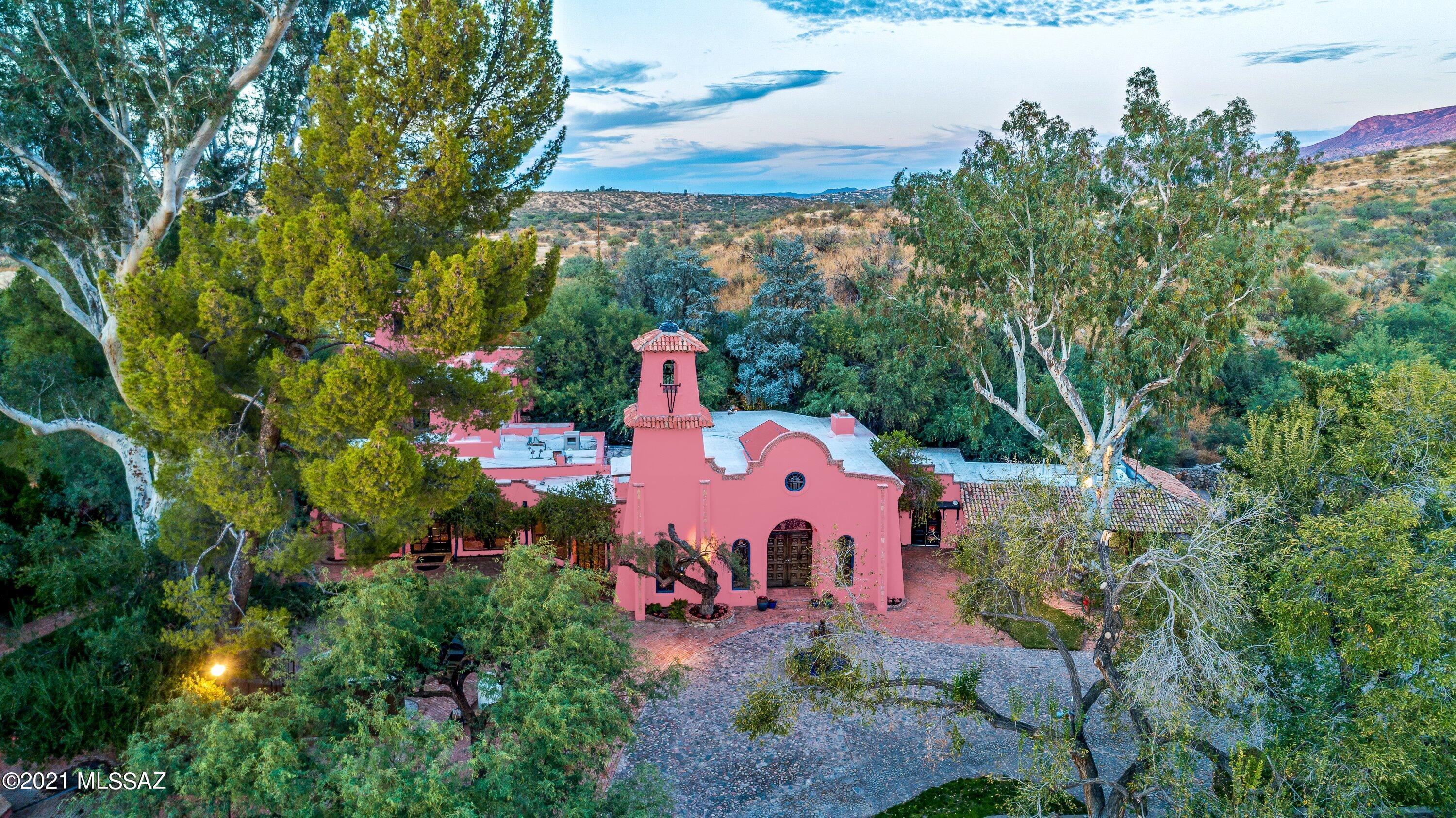 Tucked away, driving down a private road, within the Catalina State Forest is the incredible Spanish style Hacienda, known as ''Rancho De Los Cerros''. Welcomed by paved cobble stone, lush greenery and matured trees, you enter a time capsule of history and privacy, surrounded by breathtaking mountain and Sonoran desert views.  
The original 1906 110sqft homestead evolved over the past 115 years into this spectacular 8000sqft estate, Stables, multiple guest houses and quarters, a beautiful pool with entertainment bar, outside fire pits and BBQ areas, including guest hosting facilities that can accommodate up to 1000 guests. 
For the true equestrian at heart the estate offers stables with a beautiful arena and irrigated pasture. And do not forget the endless riding trails within the Catalina state park.
With this being the ONLY privately owned property within the Catalina State Park Additional Special features include a wine cellar, a 60x60 garage with RV hookup and a Private well. 
A masterpiece worthy of being experienced.