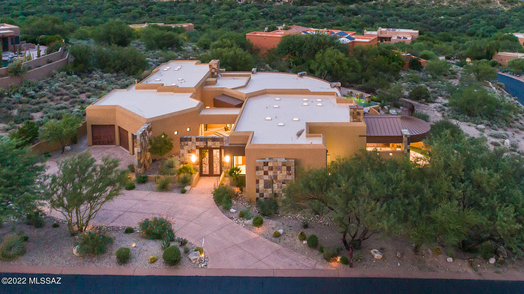 Welcome to Red Mountain Dr., a resort-like retreat sited on 1+ acres  in Coyote Ridge boasting panoramic, breathtaking views of Pusch Ridge. Gated courtyard  w/fountain leads to entry inviting you into open floor plan w/spacious LR/DR featuring hand-scraped cherry flooring, floor to ceiling 24 FT radius sliding doors offering abundant natural lighting throughout. Chef's kitchen showcases Decor SS appliances, Italian marble island w/accent counters, bar seating, & butler's pantry w/150 bottle  wine refrig. FR off kitchen w/butterscotch slate accent that flows seamlessly to multitude of outdoor spaces including outdoor kitchen & pool/spa. Accentuating primary suite includes spa-like bath, FP & Miele coffee maker. Endless bonus features include 3 ample sized en-suite guest rooms & much more!