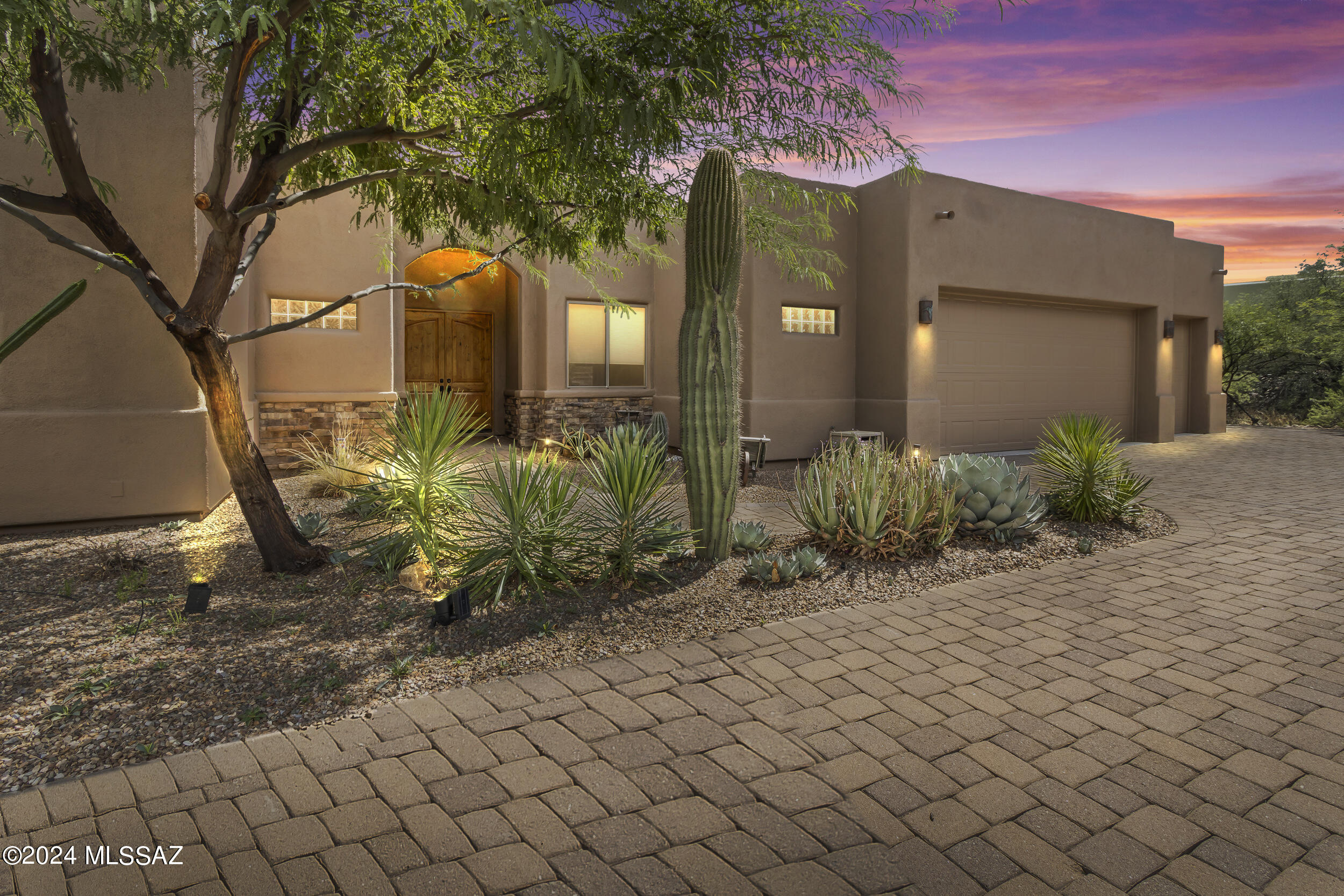 Welcome Home! This stunning property, nestled on an elevated .57 acre lot on a cul de sac street in Sunridge II, offers unparalleled privacy and breathtaking views. On the market for the first time, this beautifully designed home features a split floor plan with 4 spacious bedrooms and 3 full baths. One of the bedrooms is an en suite, perfect for guests. You'll be captivated by the 20 ft. ceilings in the great room, complete with built-in speakers, and the floor-to-ceiling windows that frame the awe-inspiring views. During the cooler months, enjoy the ambiance of the see-through gas fireplace that warms both the great room and dining area. The open floor concept creates an ideal space for entertaining. 
In 2021, this home received several updates including freshly painted interiors, new tile flooring in the bedrooms, an upgraded primary bath shower, and top-of-the-line appliances like a 36" Subzero refrigerator, a Wolf 30" gas smart range with convection oven, a new GE microwave and wall convection oven, a Bosch dishwasher, and refinished cabinets. The primary suite boasts a walk-in shower with dual heads and an oversized closet, providing ample storage. The laundry room is well-equipped with a sink and additional cabinetry. Step outside to your private oasis where you can relax in the pool and spa while enjoying unobstructed views of the Catalina Mountains. The wrap-around patio is perfect for gatherings, featuring a built-in BBQ and mini fridge. Plus, there's plenty of space for your vehicles and storage needs in the 3-car garage. This home is a rare find and offers everything you need for luxury living and entertaining.
