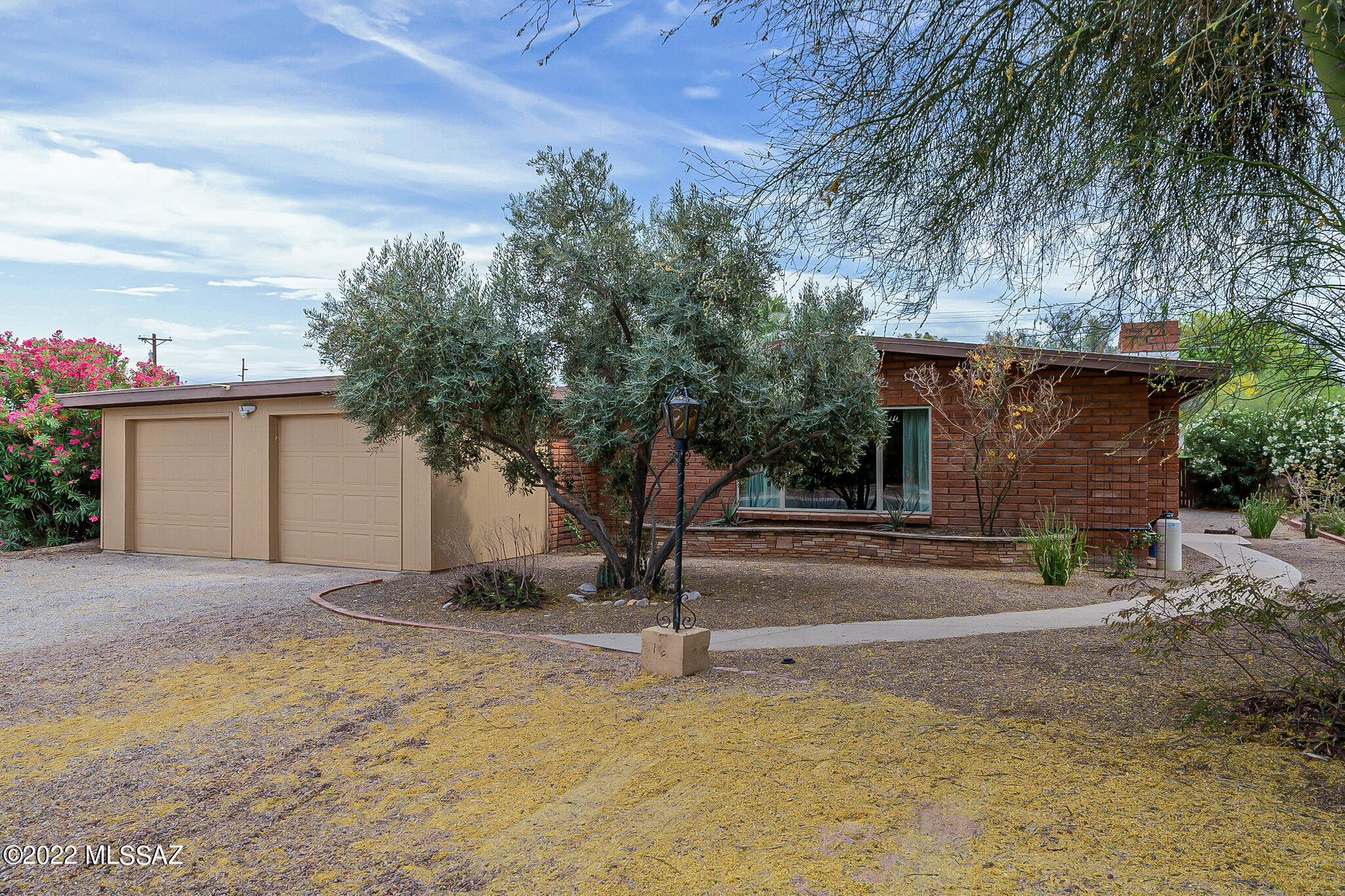 Beautiful mid-century style burnt adobe home in the lovely Mitman subdivision. This home move in ready and has an open floor plan, vaulted ceilings, and a huge bonus room off of the kitchen. The bonus room has a fireplace, separate entry and could be used as a guest quarters, additional living room, studio, den or exercise room. Additional interior features include a stone fireplace in the living room, a recently remodeled kitchen, granite slab counters, an open island that feeds into the living room, and beautiful plank tiled flooring. On top of these amazing interior features, the home has a spacious 2 car garage, large backyard with a built in BBQ, and covered patio. The HVAC is newer and the home has energy-efficient windows. Truly a fantastic move in ready home!