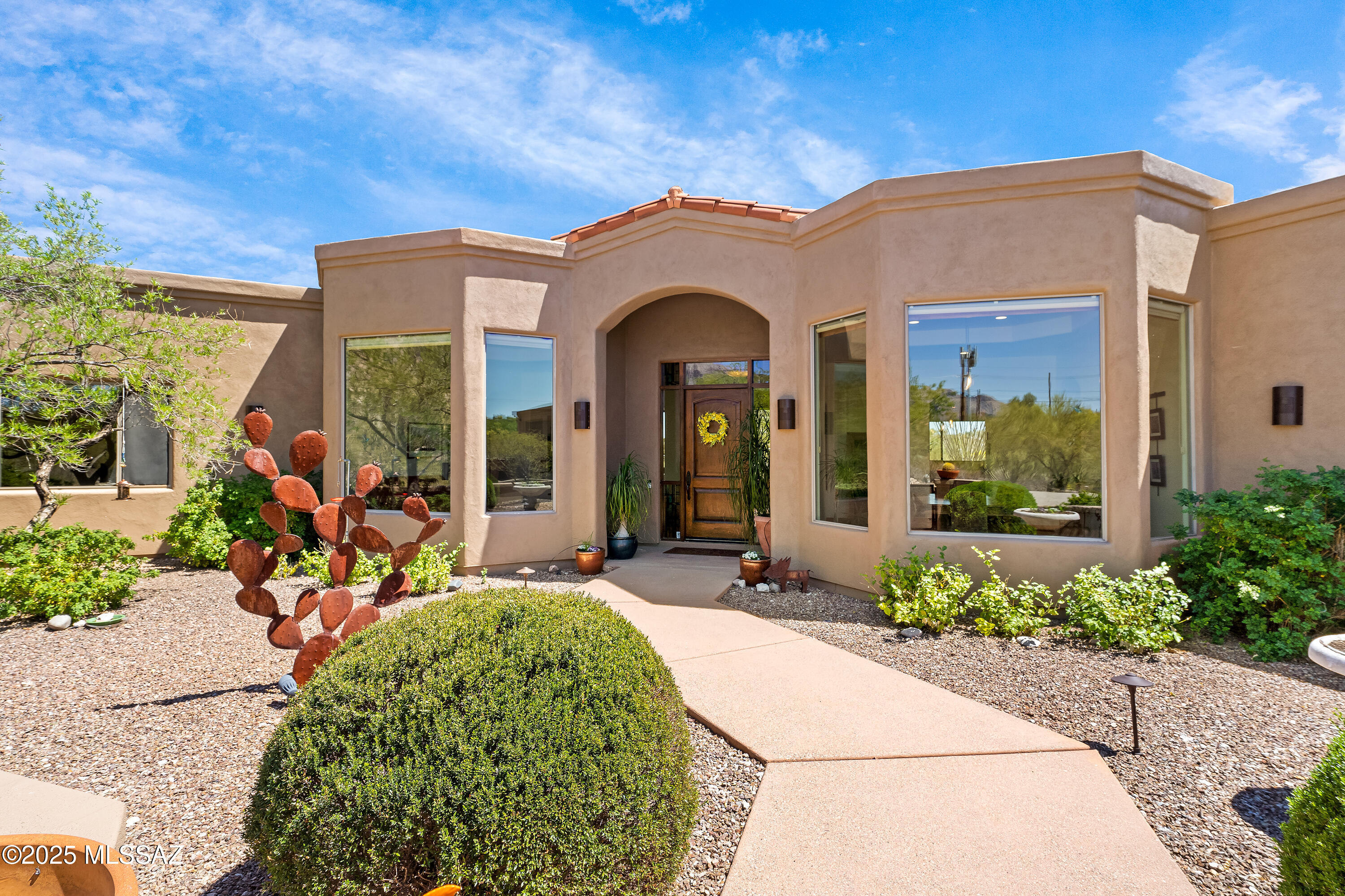 Gorgeous custom-built home in the heart of central Catalina Foothills! Open floorplan with abundant natural light and picturesque views through expansive windows. Custom gate at top of driveway; rare 1500 sf oversized 4-car garage/workshop with 10'6'' ceiling height to accommodate RV. Beautifully landscaped front courtyard and backyard with patio, solar heated pool, turf and stunning views from multiple angles. Find custom mesquite and alder wood features throughout with bamboo flooring. Pool is heated via solar panels on roof. Fresh exterior paint. Home is ideal for entertaining with built in refrigerator, two dishwashers, two sinks, extra deep freezer. Open floorplan with 11'+ ceiling height throughout. No interior steps. Located within Catalina Foothills school district. Owner/Agent.
